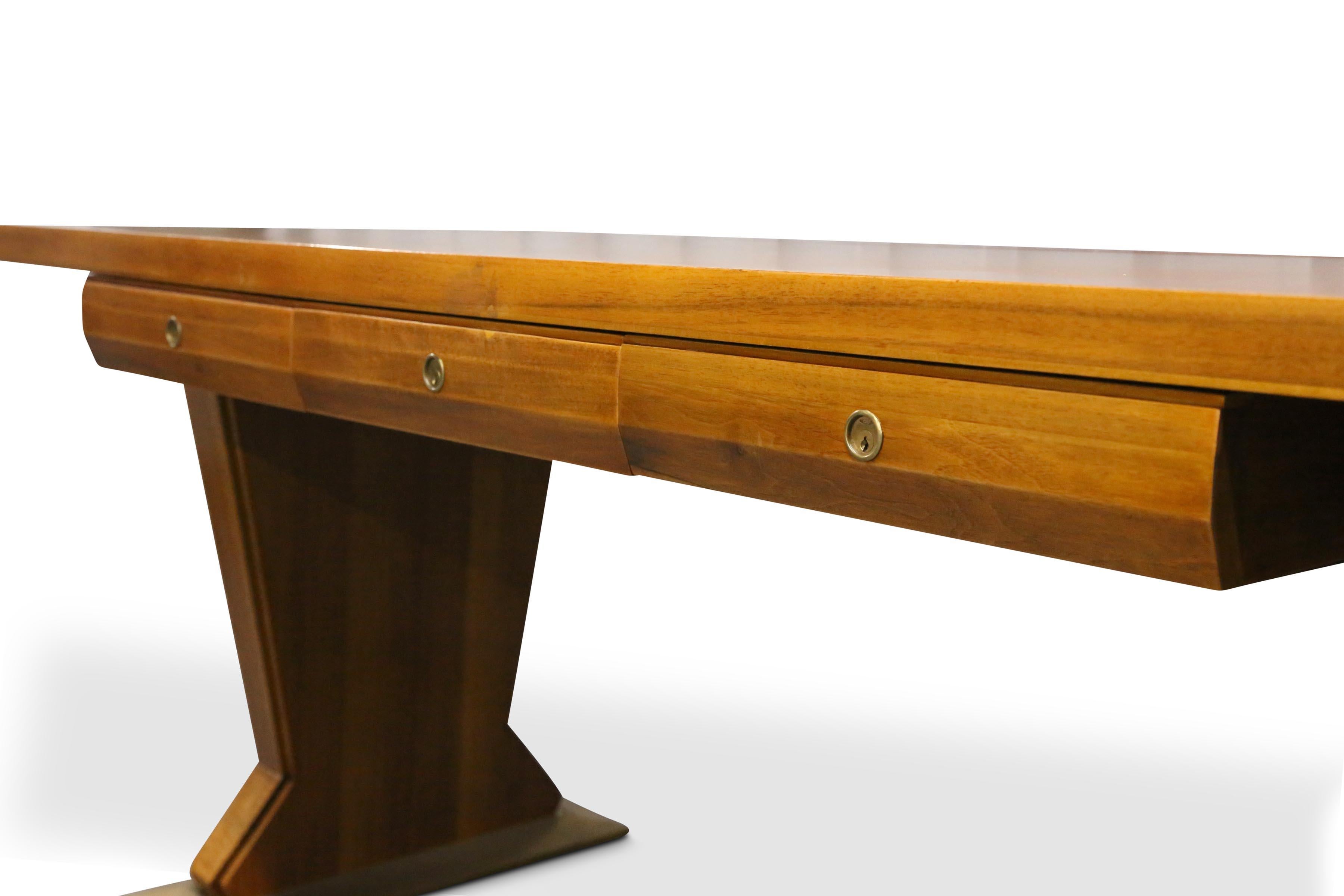 A magnificent rare 1940s Italian Boss desk designed by Osvaldo Borsani, the large rectangular walnut with a tooled brown and gilded leather top over three frieze drawers each drawer with its original working locks (no keys), both the leg fronts