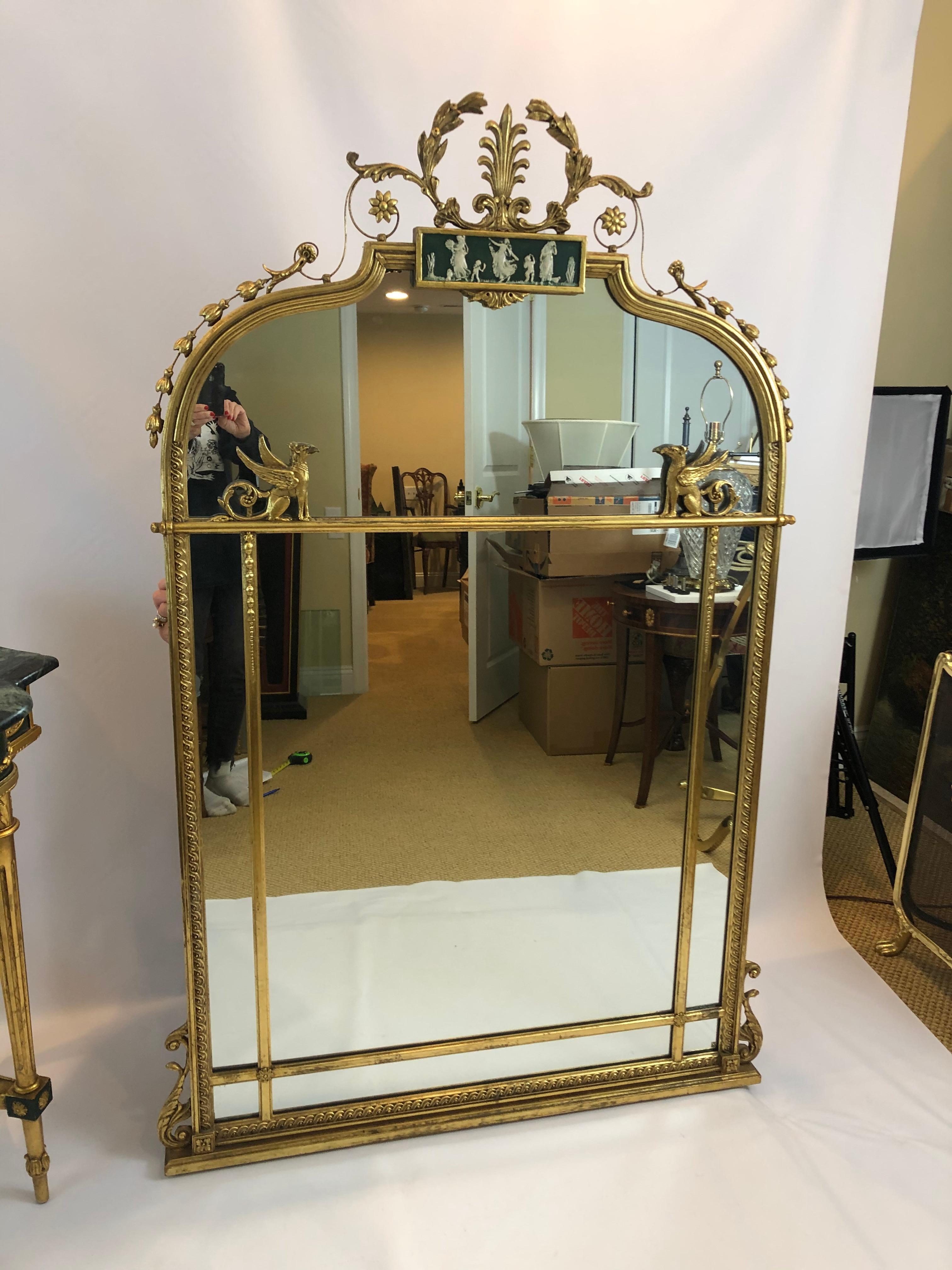 Magnificent brass large curved mirror having figural cameoesque central decoration and fabulous griffins on each side. The mirror is sold separately, but matches a gorgeous marble top console as shown in final photo.
$4350 for both pieces
At top