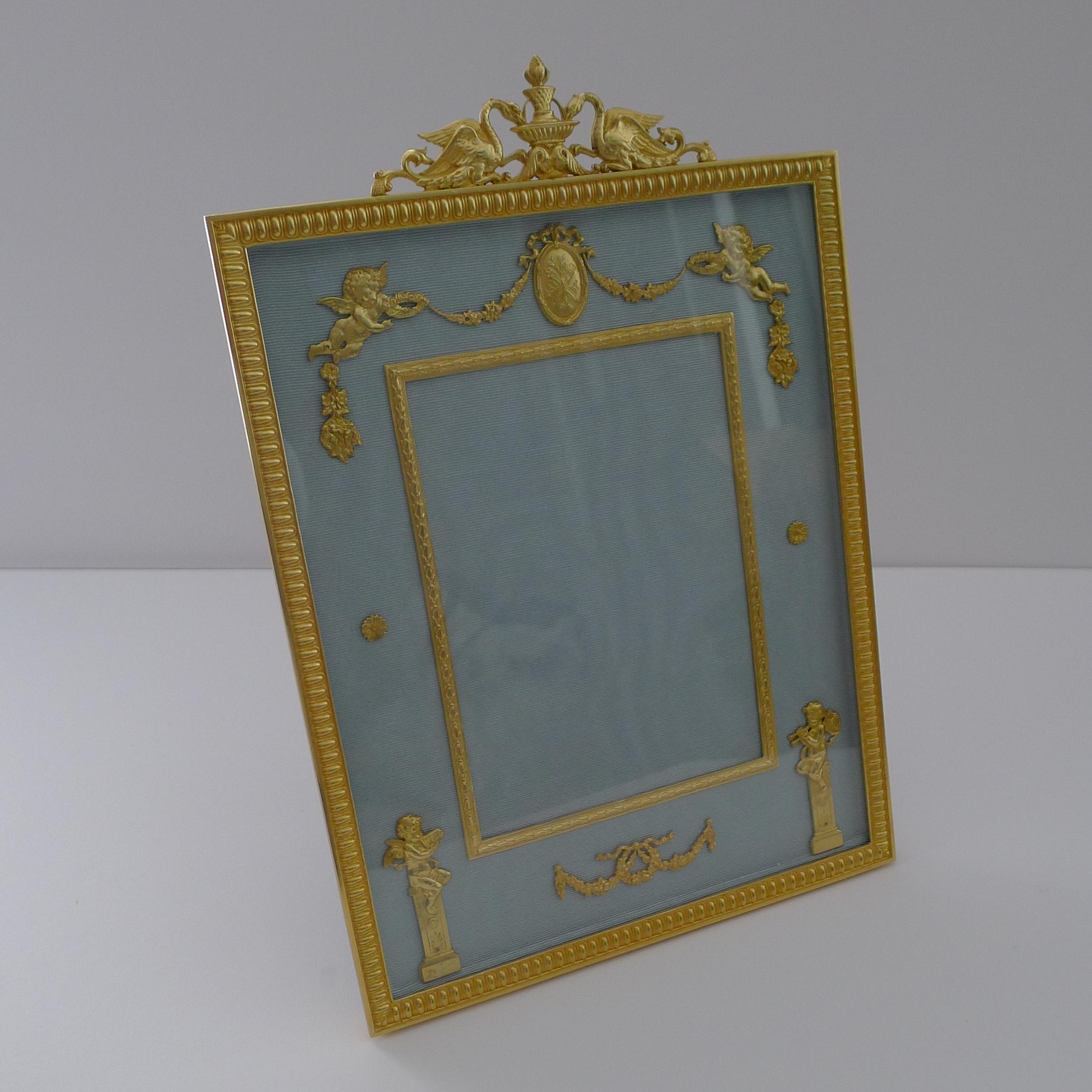 A magnificent French picture frame made from bronze and smothered in gold, beautifully restored to it's former glory and ready to adorn the finest of homes for another 100 years.

The top is crowned with a pair of Swans drinking from a fountain and