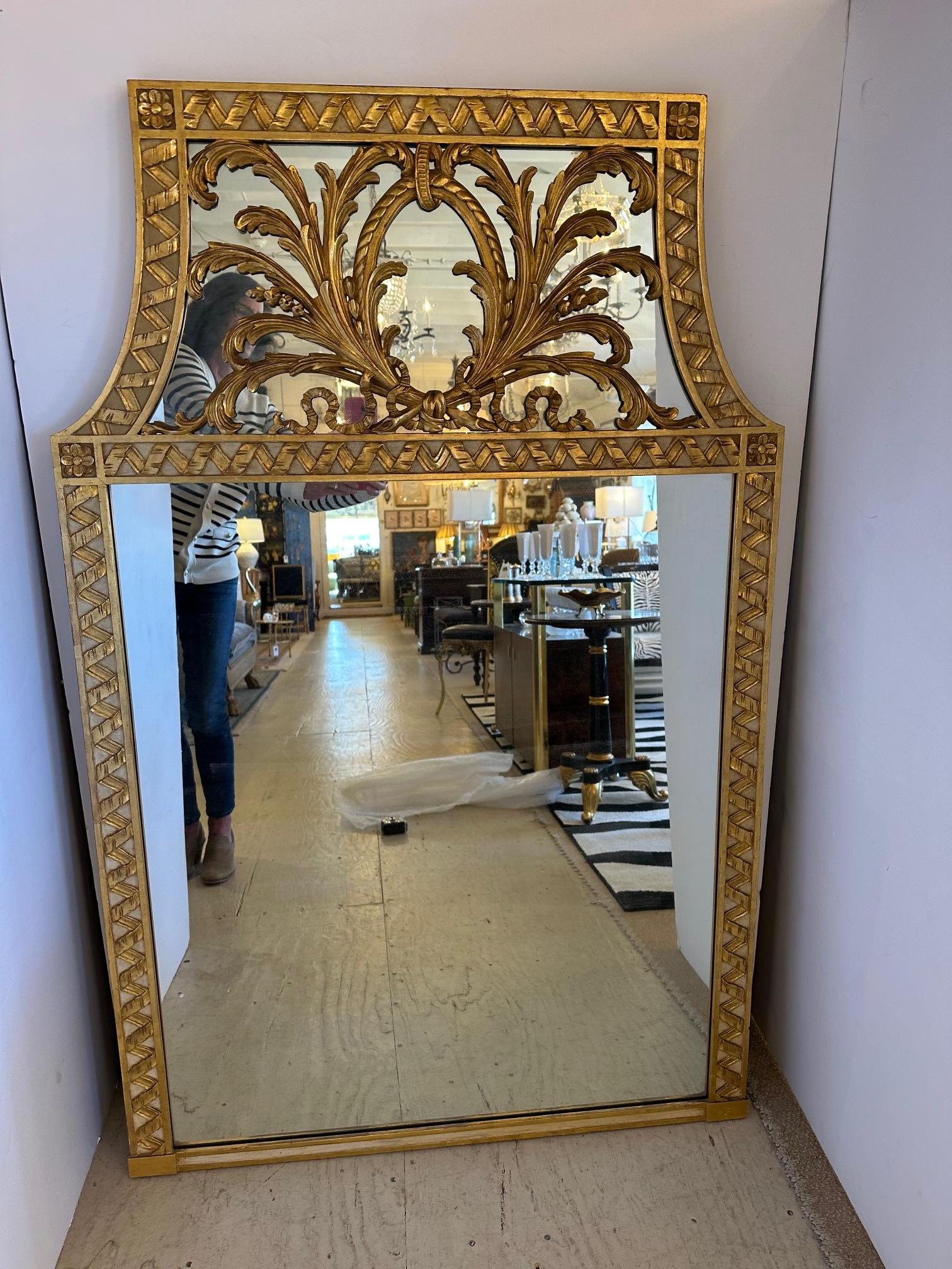Striking large and unusually shaped giltwood mirror having sculpted ornate top that curves in on each side.
