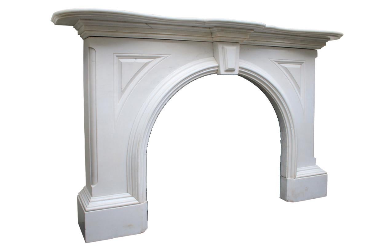 Magnificent large mid Victorian statuary white marble fireplace surround. The heavily stepped and shaped mantle sits above the keystone with a simple applied lozenge. Well deeply carved fielded panels to the spandrels. Heavy yet simple moldings
