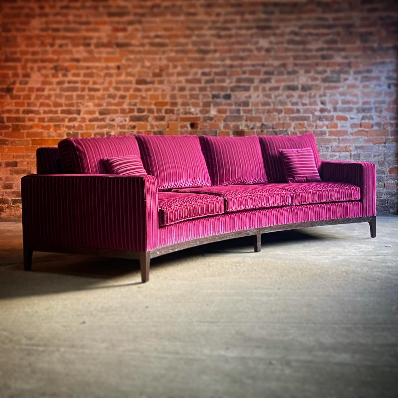 Exceptional large bespoke curved sofa of the highest quality, standing at over 10 feet in length upholstered in the most luxurious magenta velvet with a feint black stripe, bolstered with loose back and seat cushions, sitting on rich rosewood frames