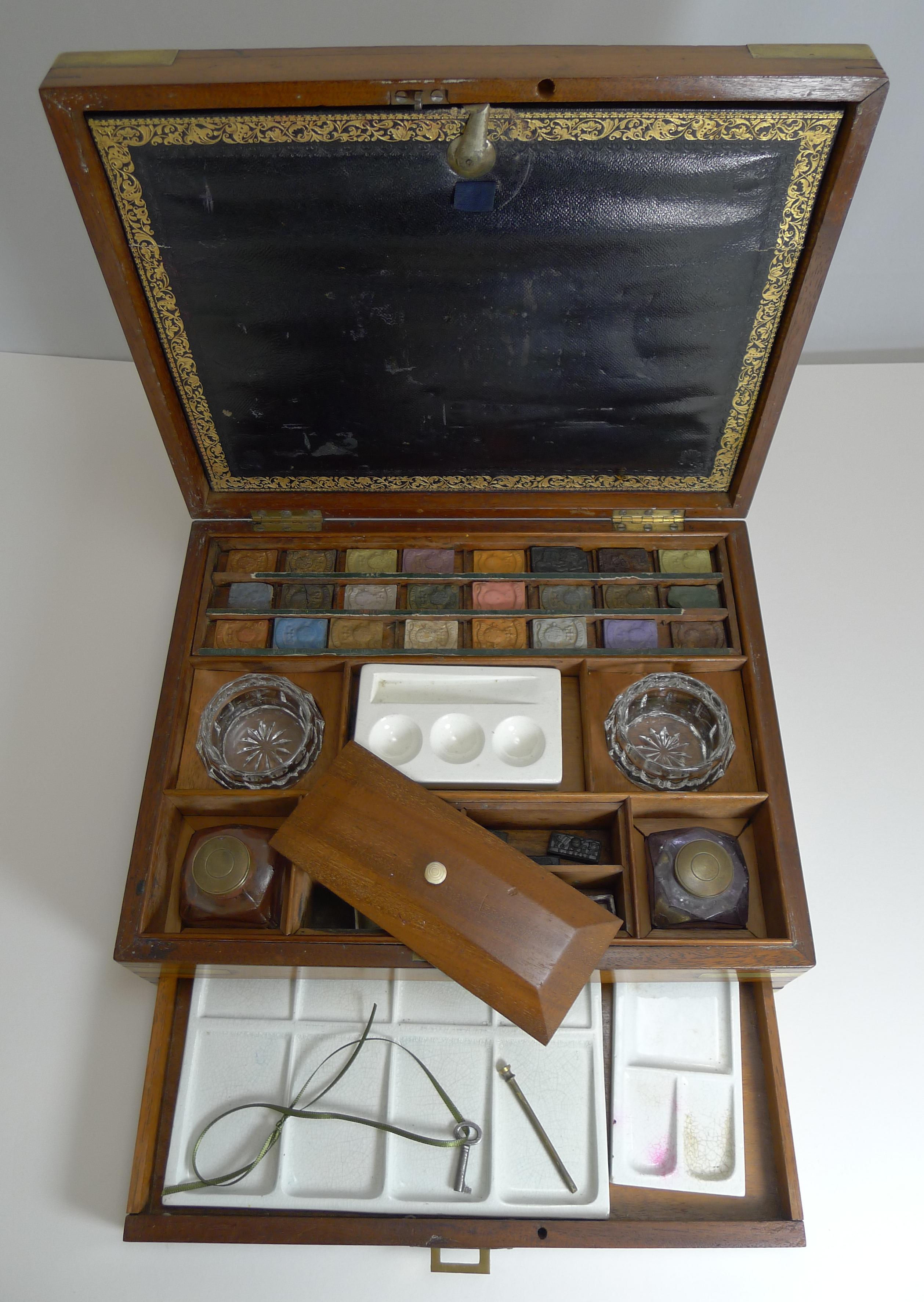 A fabulous Victorian artist / paint / watercolor box dating to circa 1860 by the famous Reeves & Sons of 113 Cheapside, London.

The box is made from mahogany, brass bound in a military / Campaign style with a flush inlaid brass handle to the