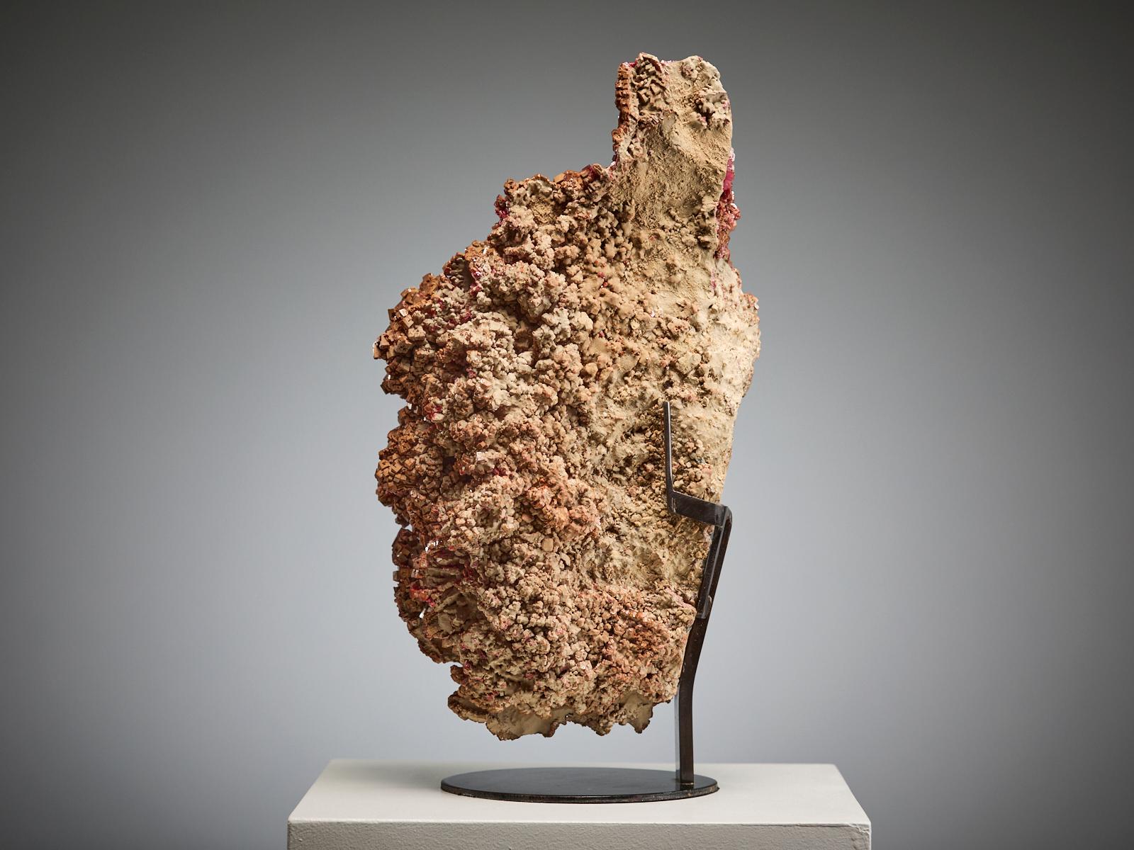 An exceptional large specimen of vanadinite from Morocco, covered entirely with brilliant, deep red crystals of varying sizes. The crystals are densely packed together, forming a continuous, sculptural surface with remarkable intensity and