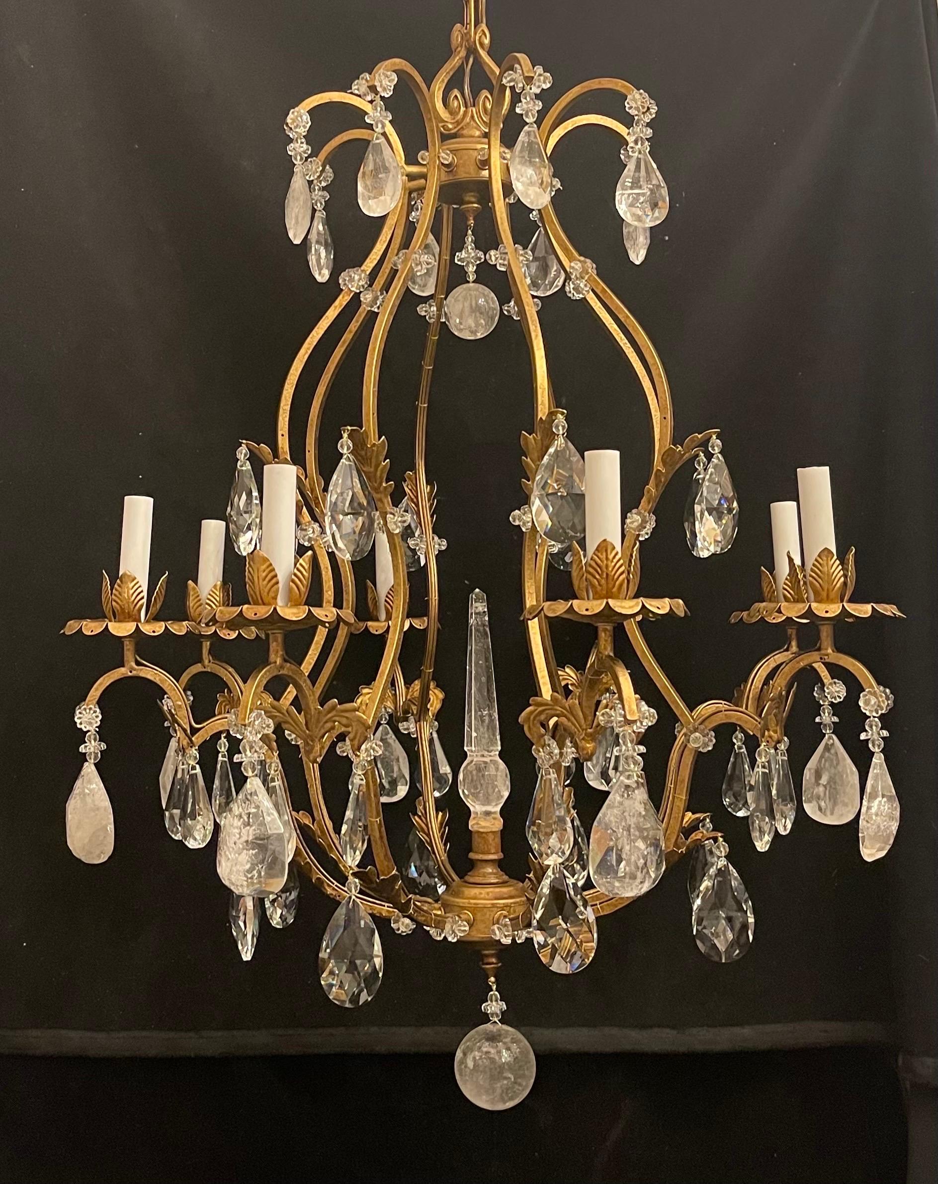 A Magnificent Maison Baguès style French rock crystal gold gilt bird cage form 8 candelabra light chandelier with rock crystal center piece spike and two rock crystal balls.
Rewired with UL and comes with chain canopy and mounting hardware for
