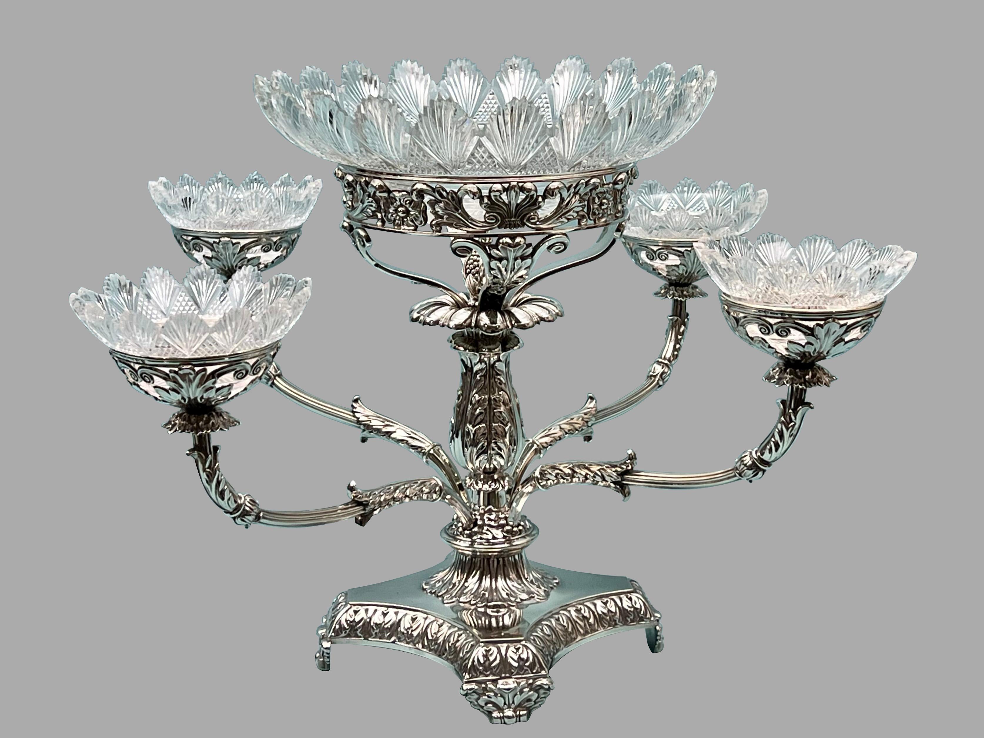 A magnificent neoclassical design sterling silver 4 branch epergne with 4 small perimeter cut glass bowls around a large central cut glass vessel, made and fully hallmarked by the famous Birmingham silversmith and manufacturer Matthew Boulton in 