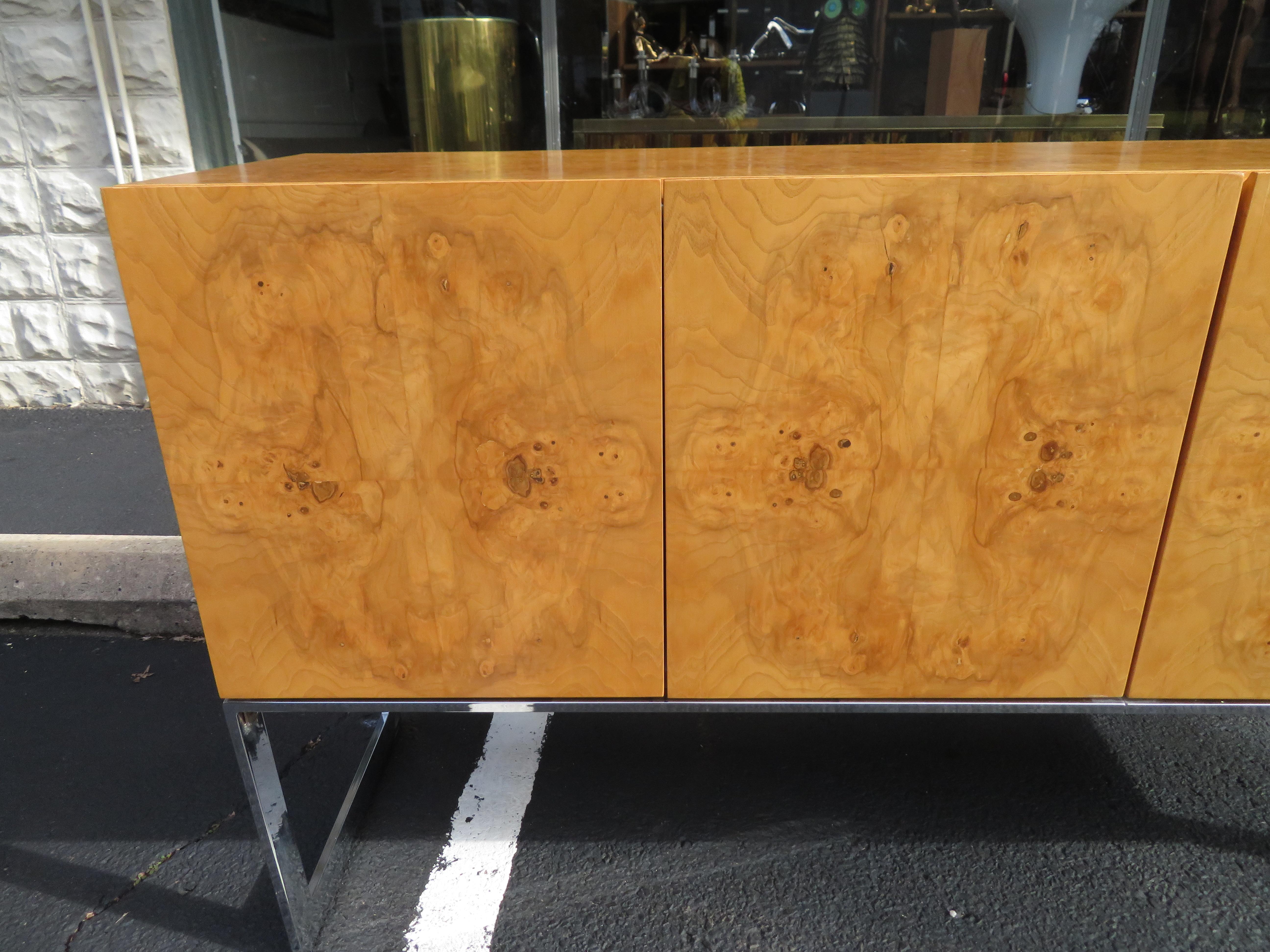 Magnificent Milo Baughman burled olive wood and chrome credenza. This particular piece is in very nice vintage condition, one of the nicest we have had in a long time. It does have the Milo Baughman label in the top drawer and the inside is clean!