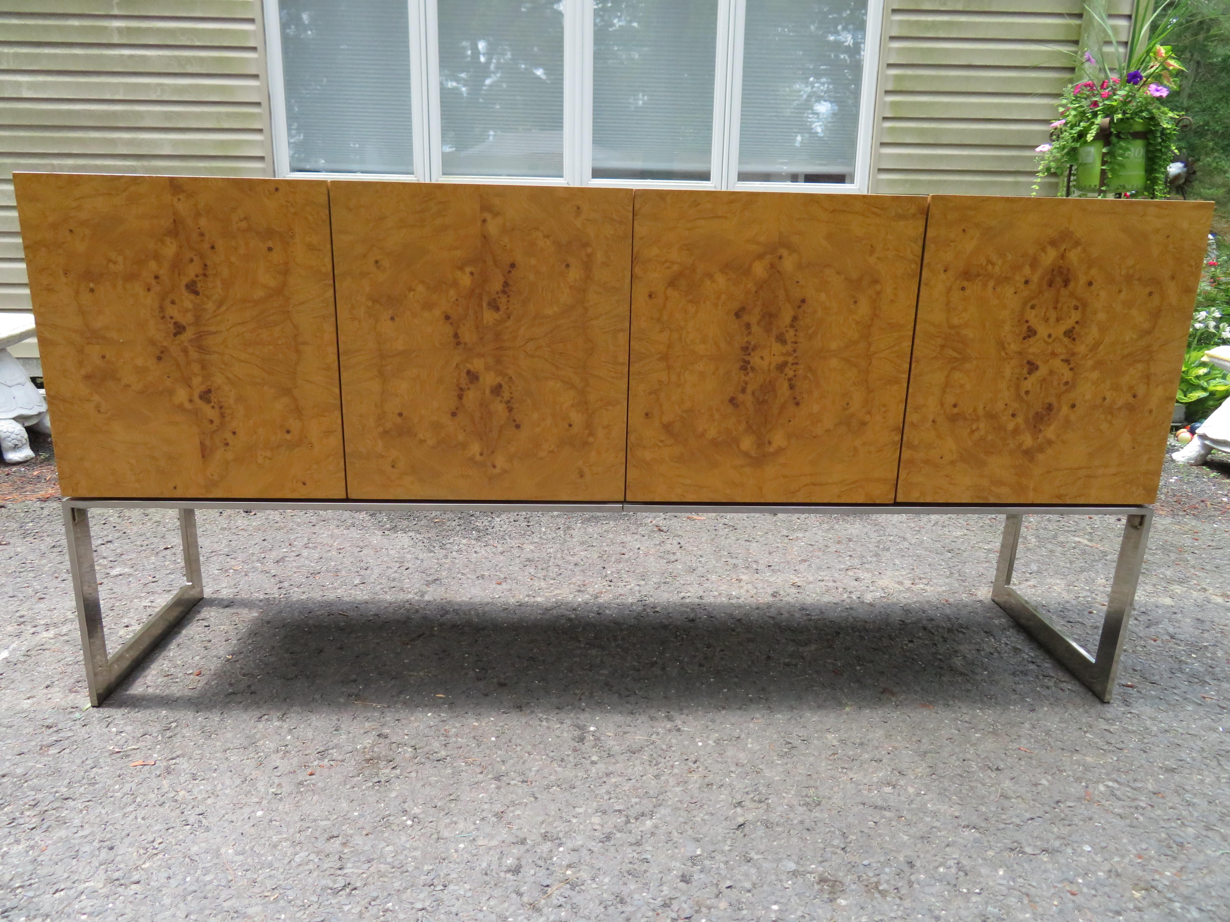 Magnificent Milo Baughman burled olive wood and chrome credenza. This particular piece is in very nice vintage condition, one of the nicest we have had in a long time. It does have the orange velvet silverware dividers in the drawers and the inside