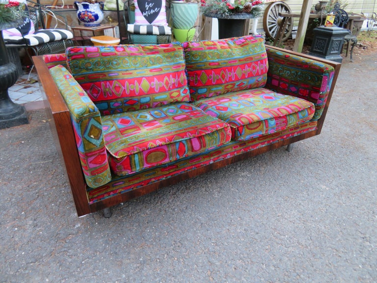 Stunning Milo Baughman rosewood loveseat with Jack Lenor Larsen Caravan velvet fabric. This piece is magnificent to see in person with its original Jack Lenor Larsen velvet. The upholstery does have some condition issues with some repairs and holes