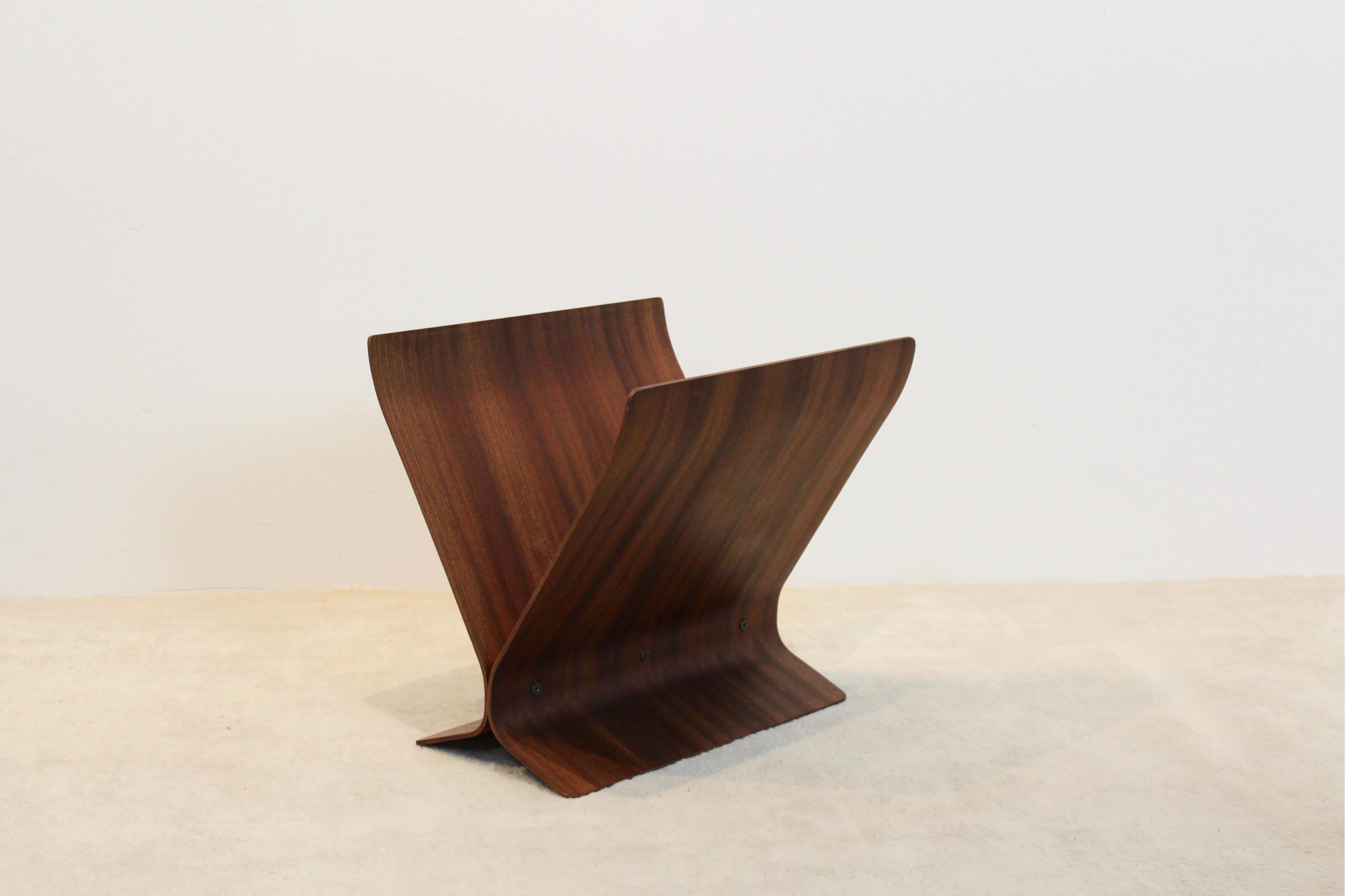 A magnificent magazine rack of bent rosewood pieces, layered and finished with a mahogany veneer, lend this piece a warm richness that hasn't faded a bit since it was constructed in the 1960s. Canadian origin and designed by Paul Rowan for Umbra in