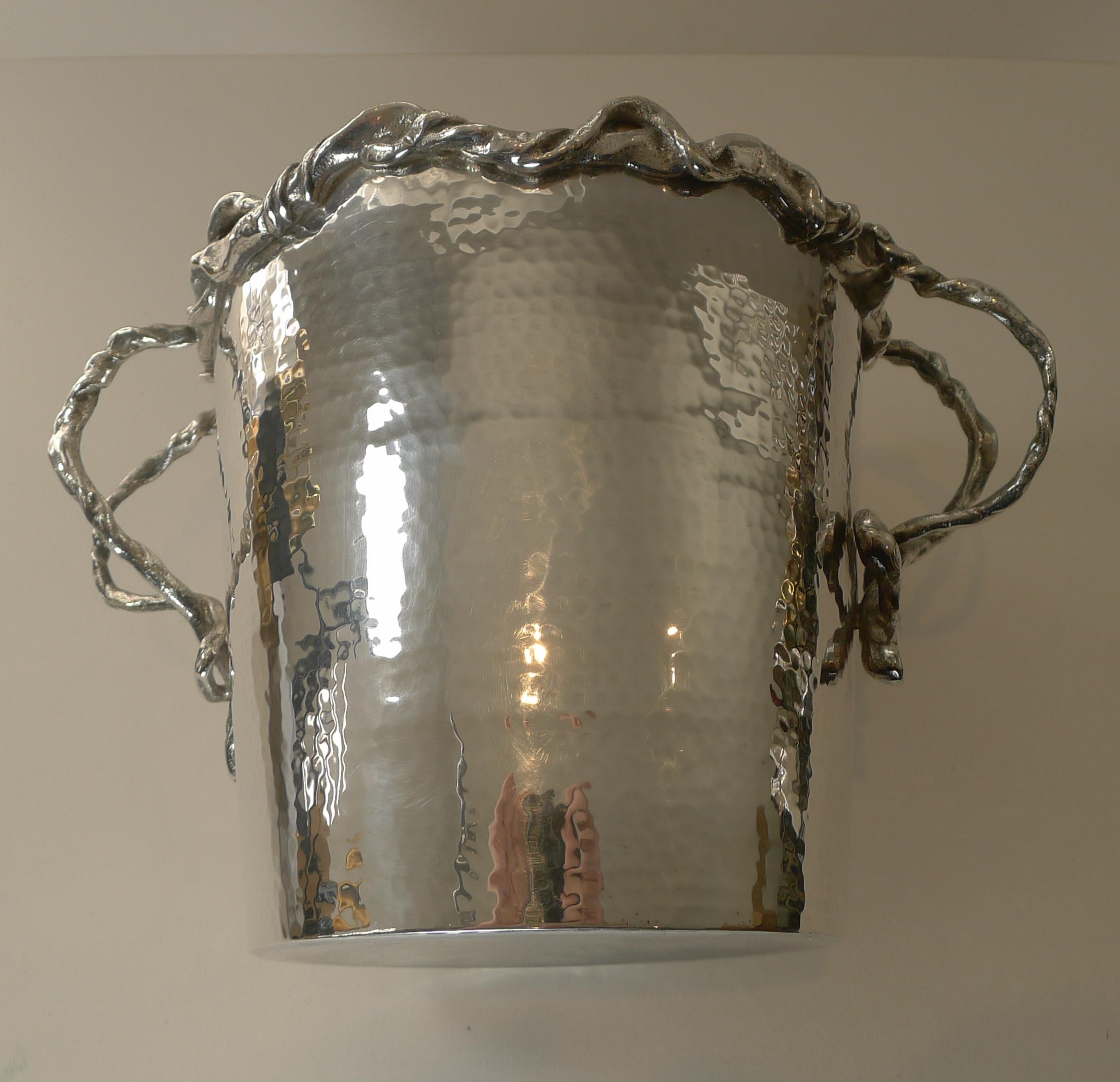 A truly stylish and really unusual champagne bucket or wine cooler made from silver plate, lovely quality and weight.

The underside is signed but I have not been able to identify the signature, Italian in origin, sourced in Italy.

The handles