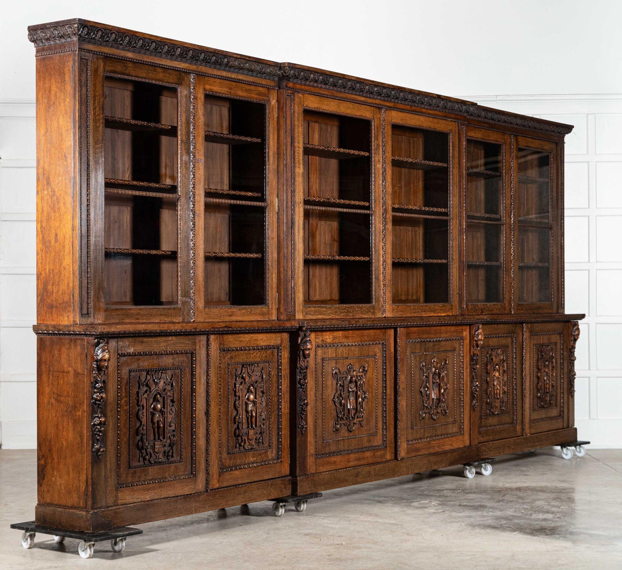 circa 1870
sku 2056
Magnificent Monumental English 19thC Carved Oak Breakfront Glazed Bookcase
Provenence Rev Key - St Pauls Vicarage England

Together W489 x D47 x H227 cm
Base W483.5 x D47 x H91 cm
Top W489 x D37 x H136 cm
Top right section