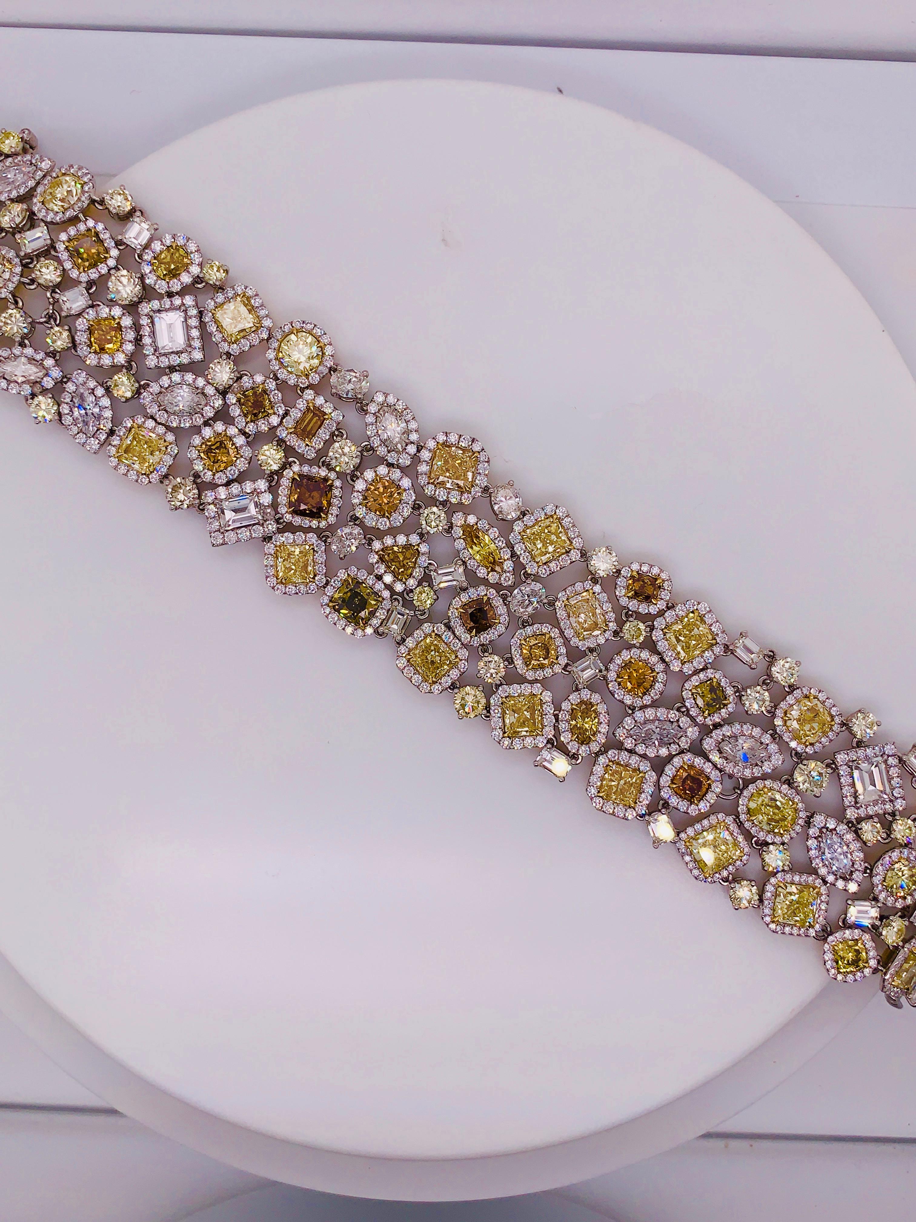 Cushion Cut Diana M. Platinum multi-colored and multi-shaped diamond bracelet featuring 58ct For Sale