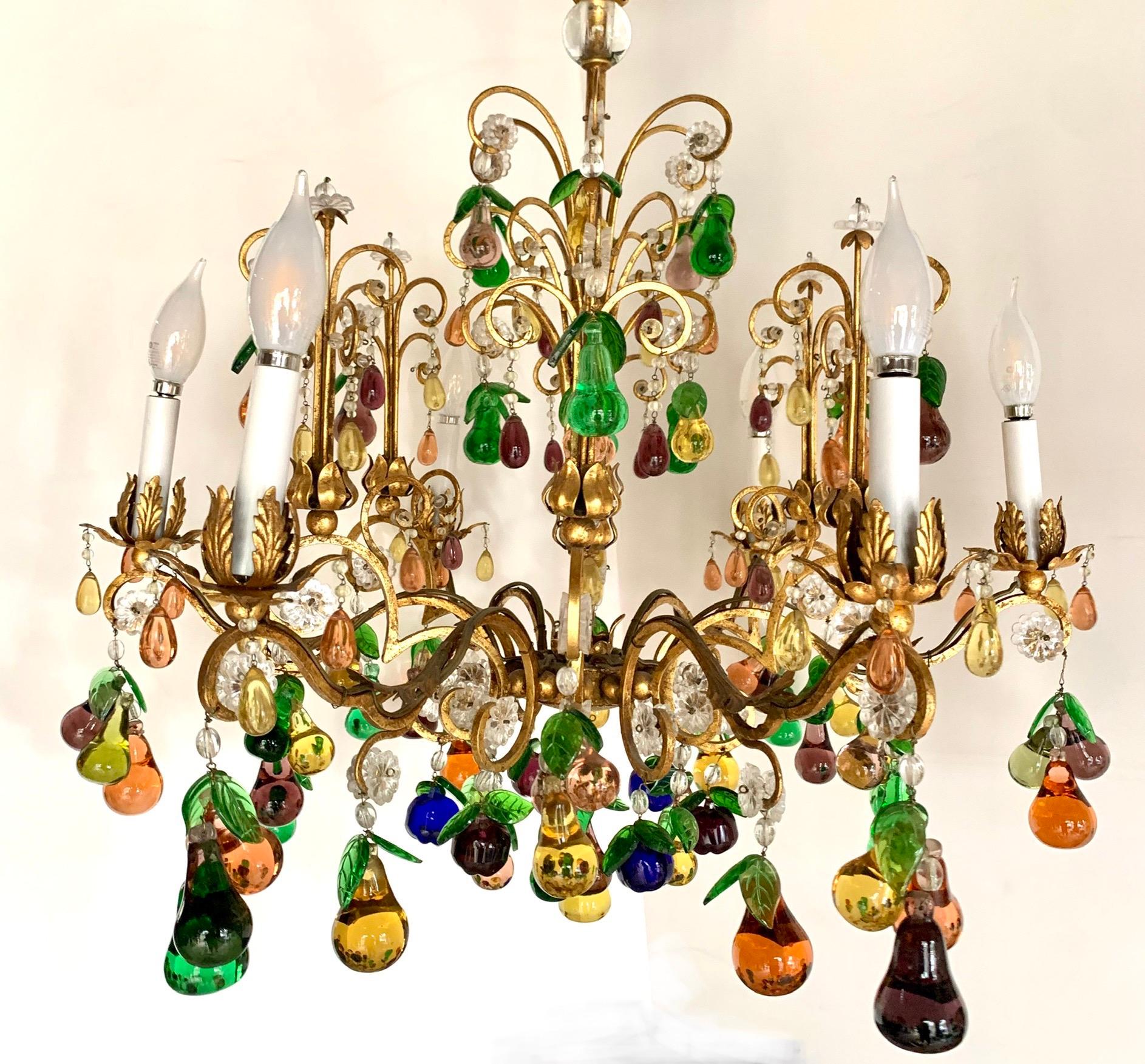 Stunning large gilt metal six light chandelier features hundreds of multi-colored murano glass fruit and crystal drops. Wired and in working condition. Includes ceiling cap and adjustable chain so chandelier hangs 52 inches from top to bottom.