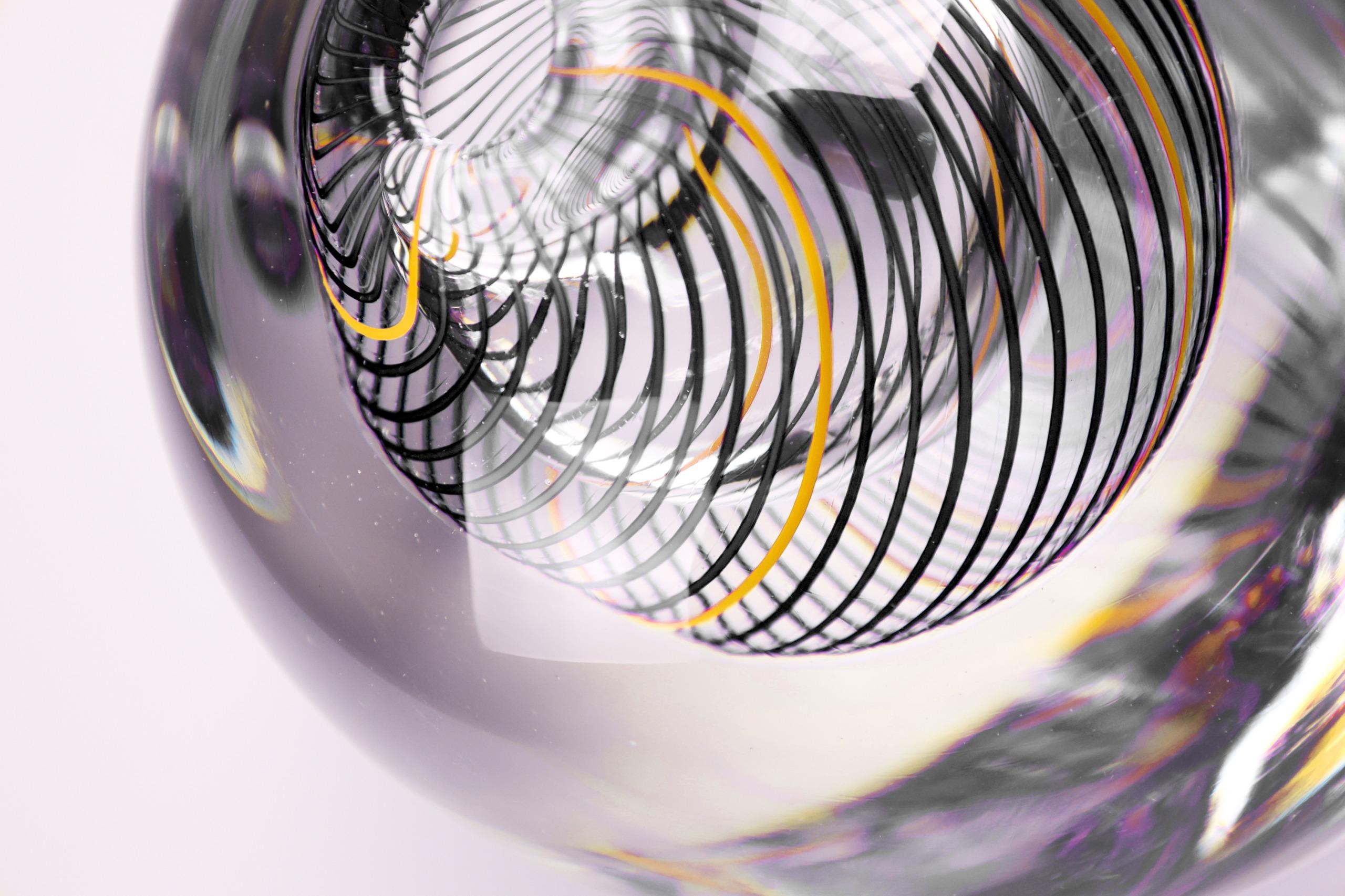 A stunning fusion of precision and playfulness, the Spyro vase is a masterful expression of contemporary Murano glass artistry. Entirely hand-blown by seasoned Venetian artisans, each piece showcases a flawless, crystal-clear silhouette that encases