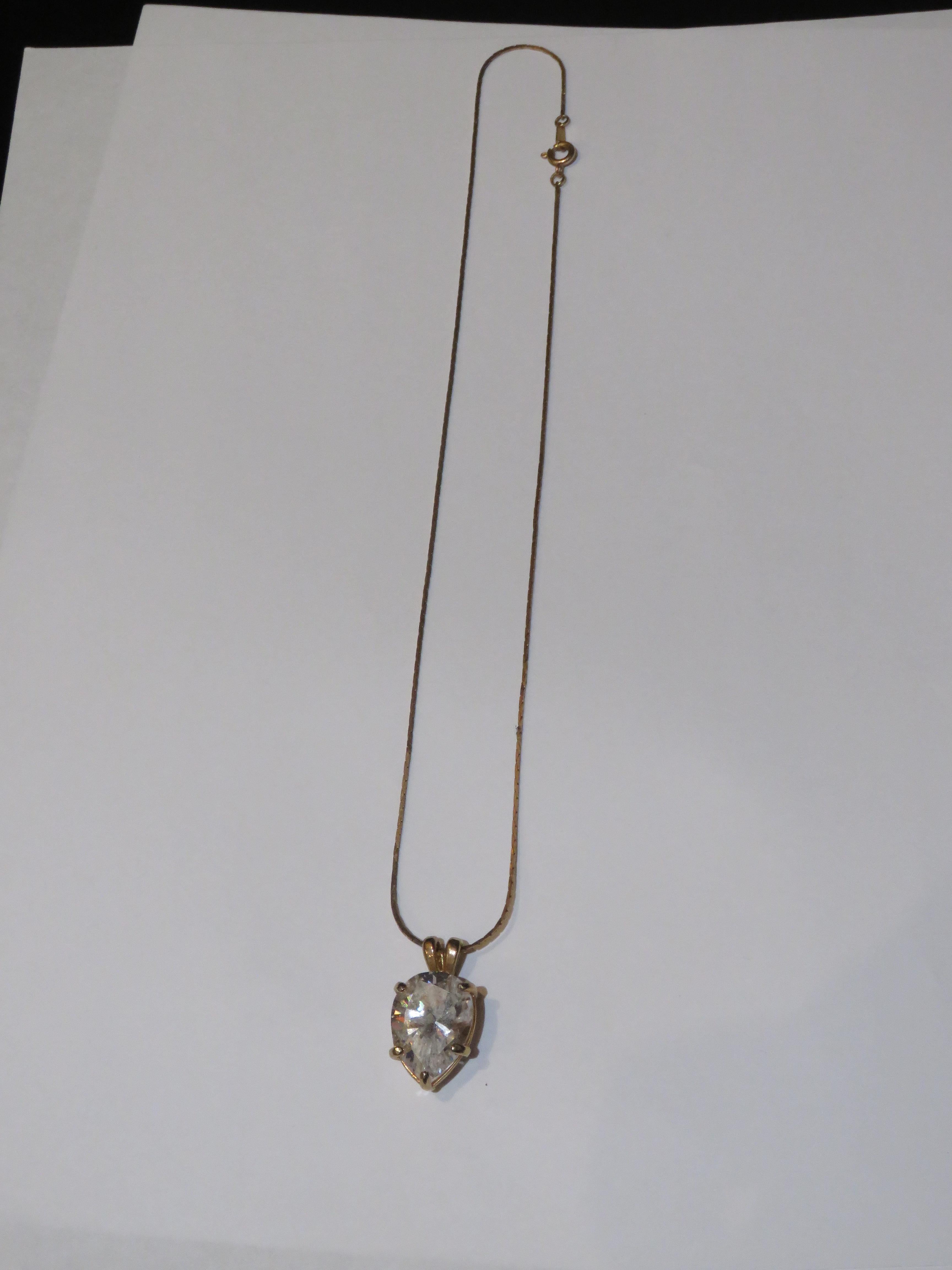 The Following Item we are offering is a Rare Important Radiant 18KT Overlaid Gold Pendant Necklace. This Gorgeous Necklace is a Vintage Large Pear Shaped Cubic Zirconia Pendant approx 6CTS on an 18KT Overlaid Gold Chain!!!Taken out of an Important