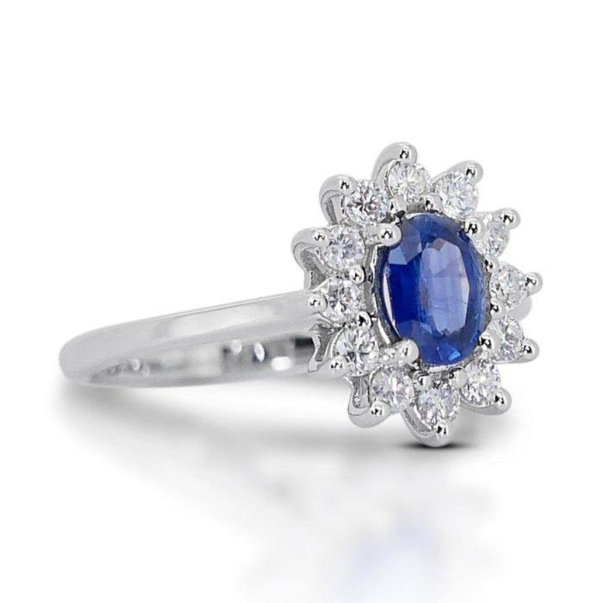 This ring isn't just an adornment; it's a portal to an ocean's depths, capturing the captivating whisper of sunlight dancing on waves. At its heart, nestled in gleaming 18K white gold, lies a magnificent 0.85-carat oval brilliant sapphire. Its