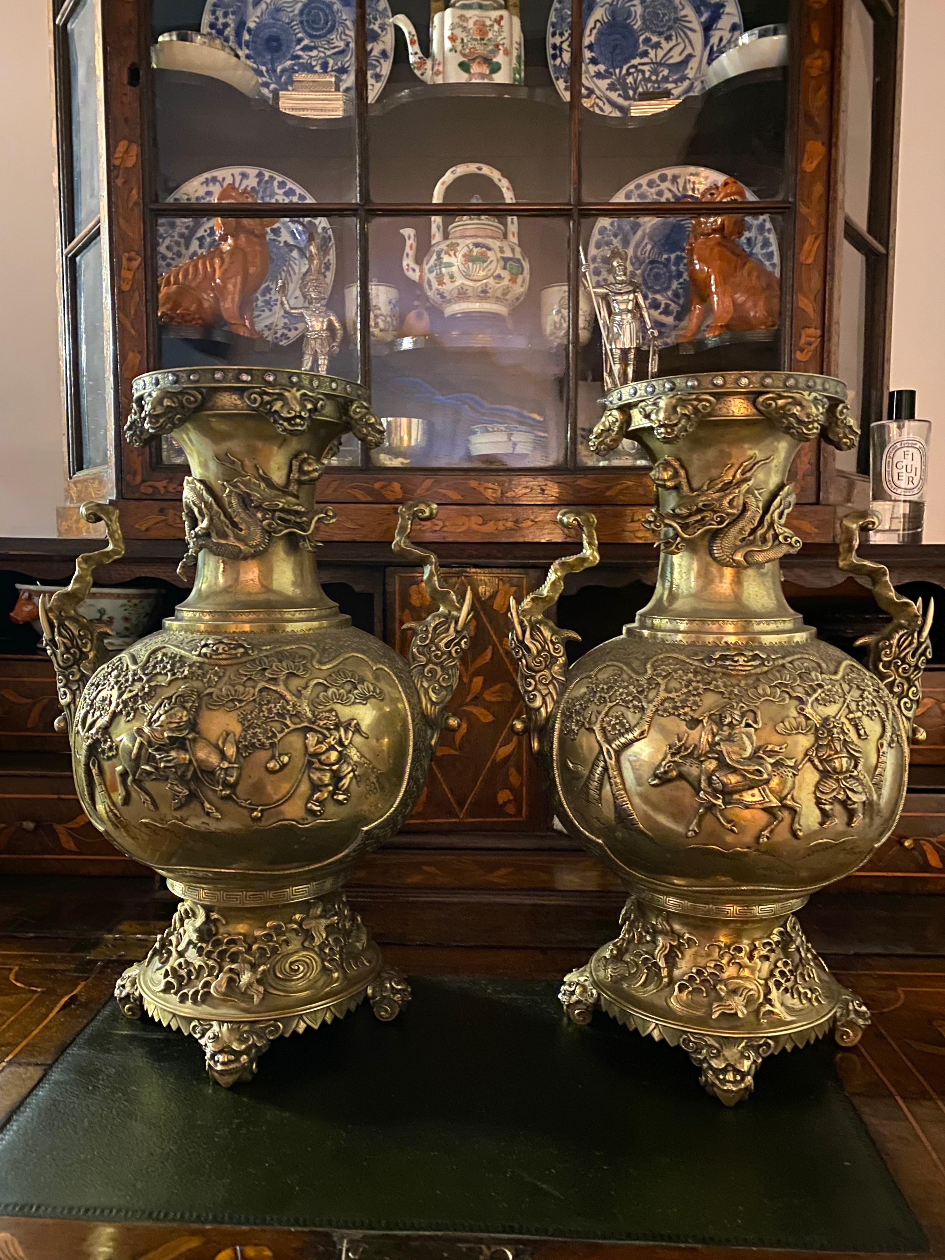 A magnificent pair of bronze 19th century Japanese vases.
Flared rim with geometric decoration to the edge with silver detailing,leading down to fine relief landscape scenes of birds, trees, floral and foliate chasing,
With superb cast relief