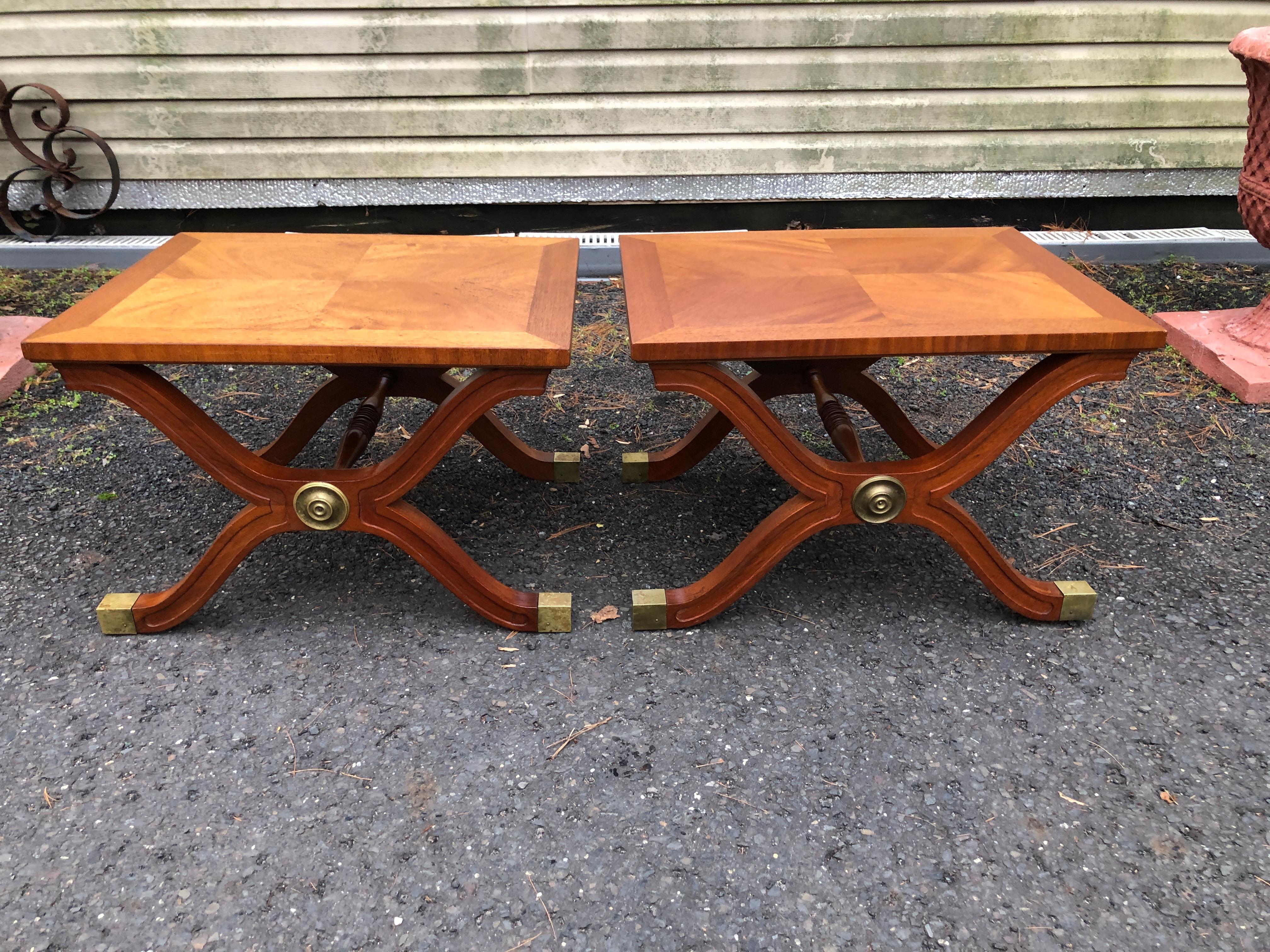 Magnificent Pair of Dorothy Draper X-base Espana side tables or benches.  This tops have lovely graining and retain their original walnut finish-only some minor wear.  We just love the gently patinated brass shrouds on the feet and a the stately