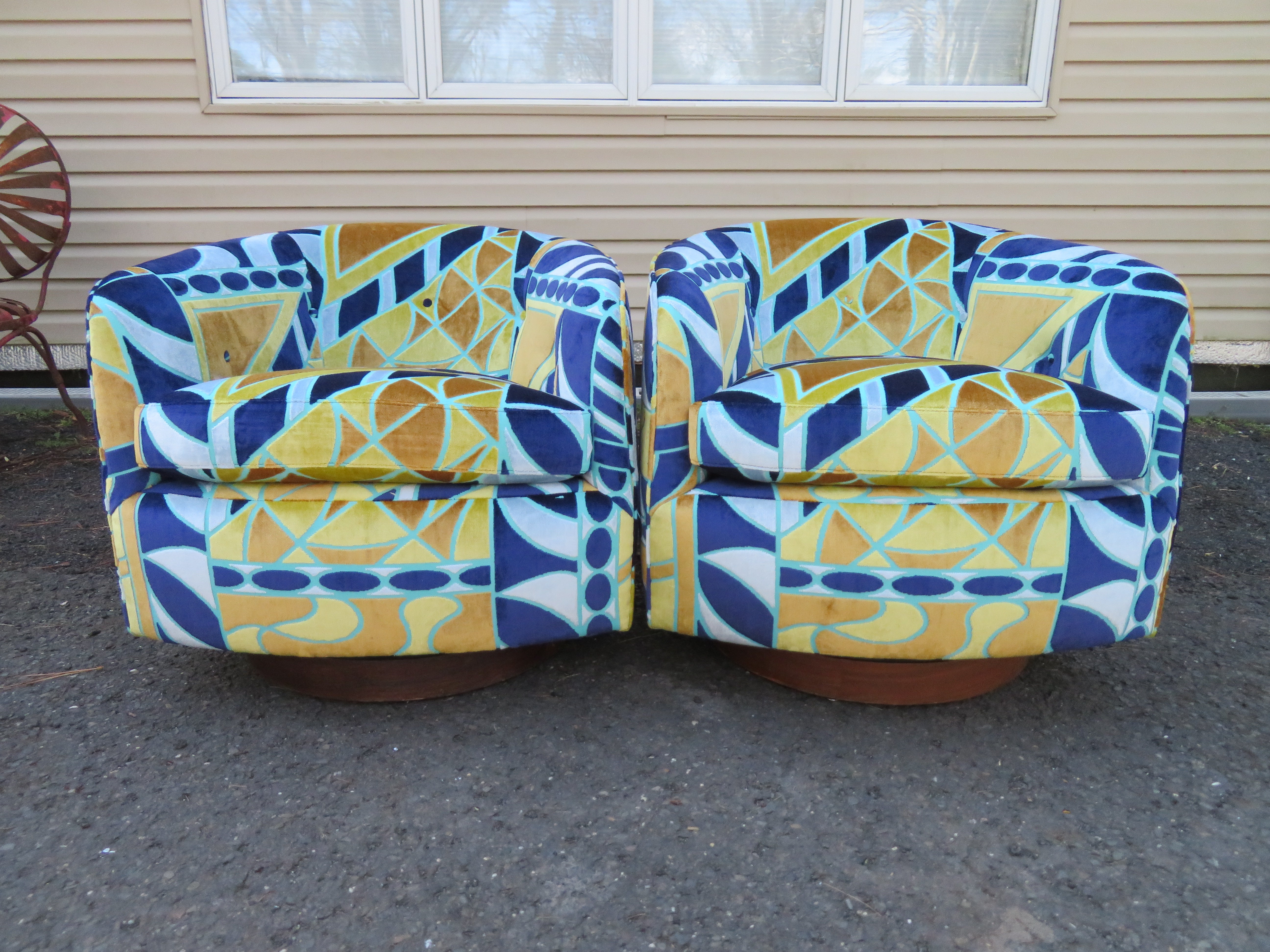 Magnificent pair of Milo Baughman swivel rocker barrel back lounge chairs. This pair has been reupholstered in the most wonderful Pucci inspired cut velvet fabric. They are breathtaking in person and are sure to impress. They measure 25