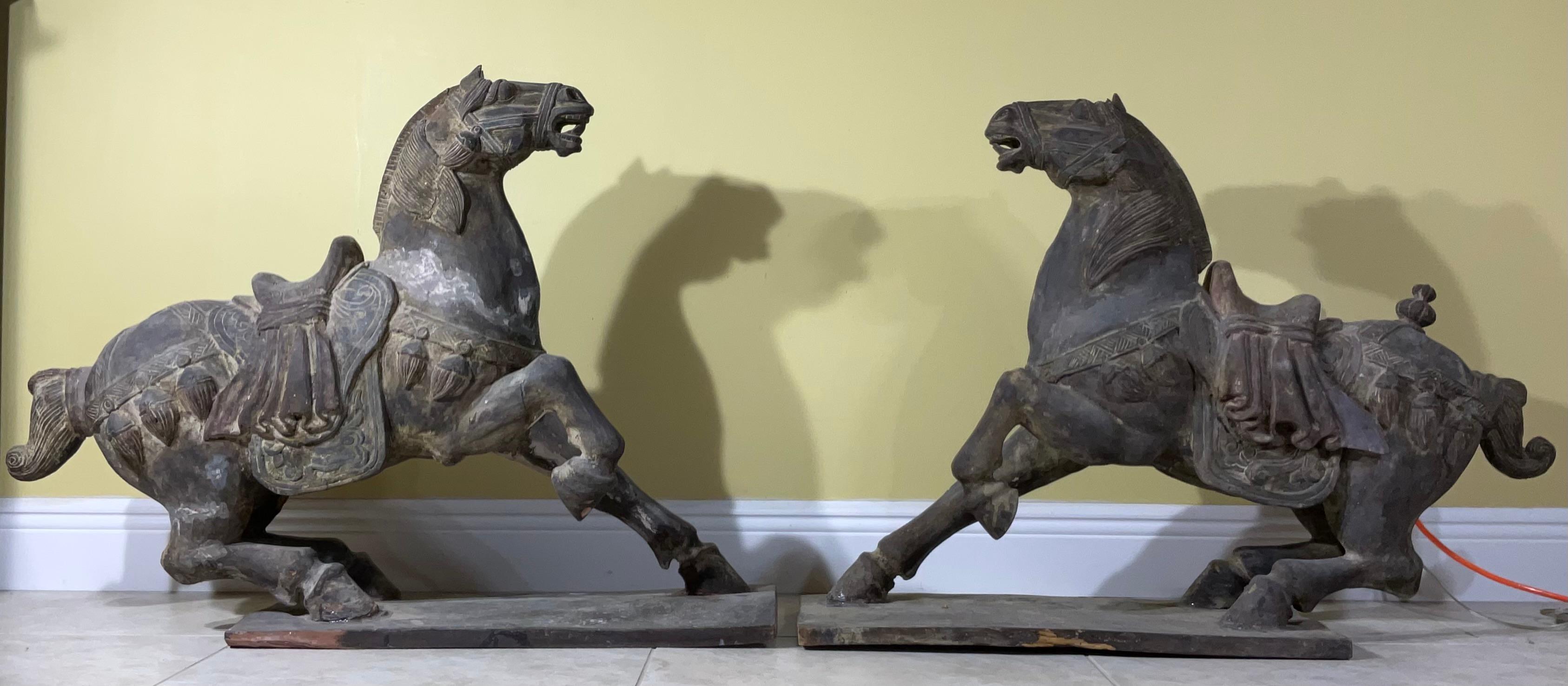 



Step back in time with this stunning pair of antique wooden horses, meticulously carved in the style reminiscent of the illustrious Tang Dynasty (618-907 AD) of China. These impressive sculptures capture the power, grace, and artistic