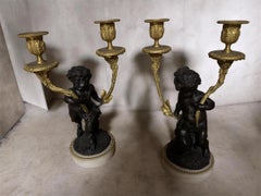 Magnificent pair of cherub candlestiks in bronze