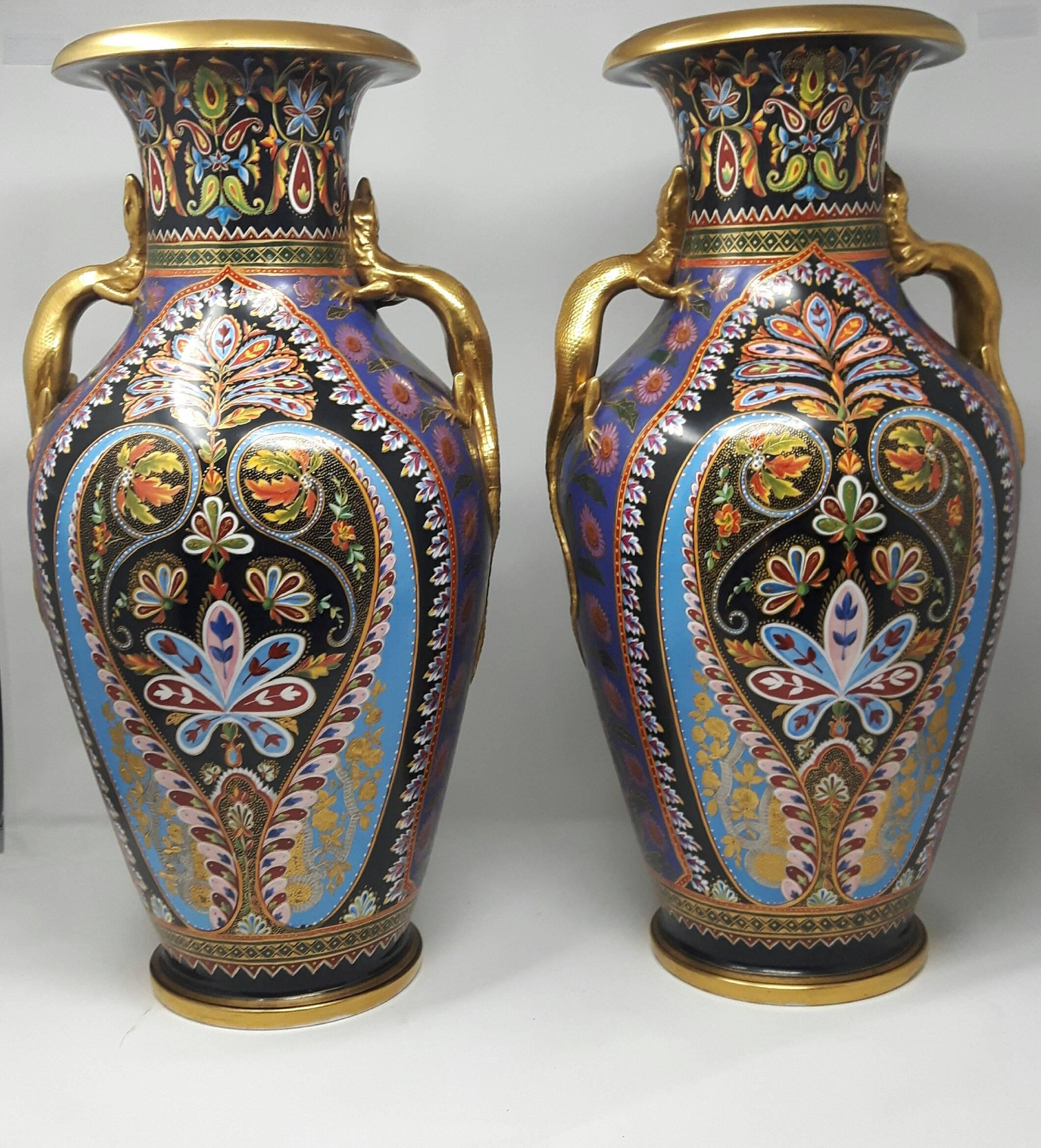 Of generous baluster shape with modelled and brightly gilded salamander handles, richly enamelled in the Cashmir style with multi-colored panels including leaf motifs in autumnal colors and raised gold on turquoise, pink and black grounds, the sides