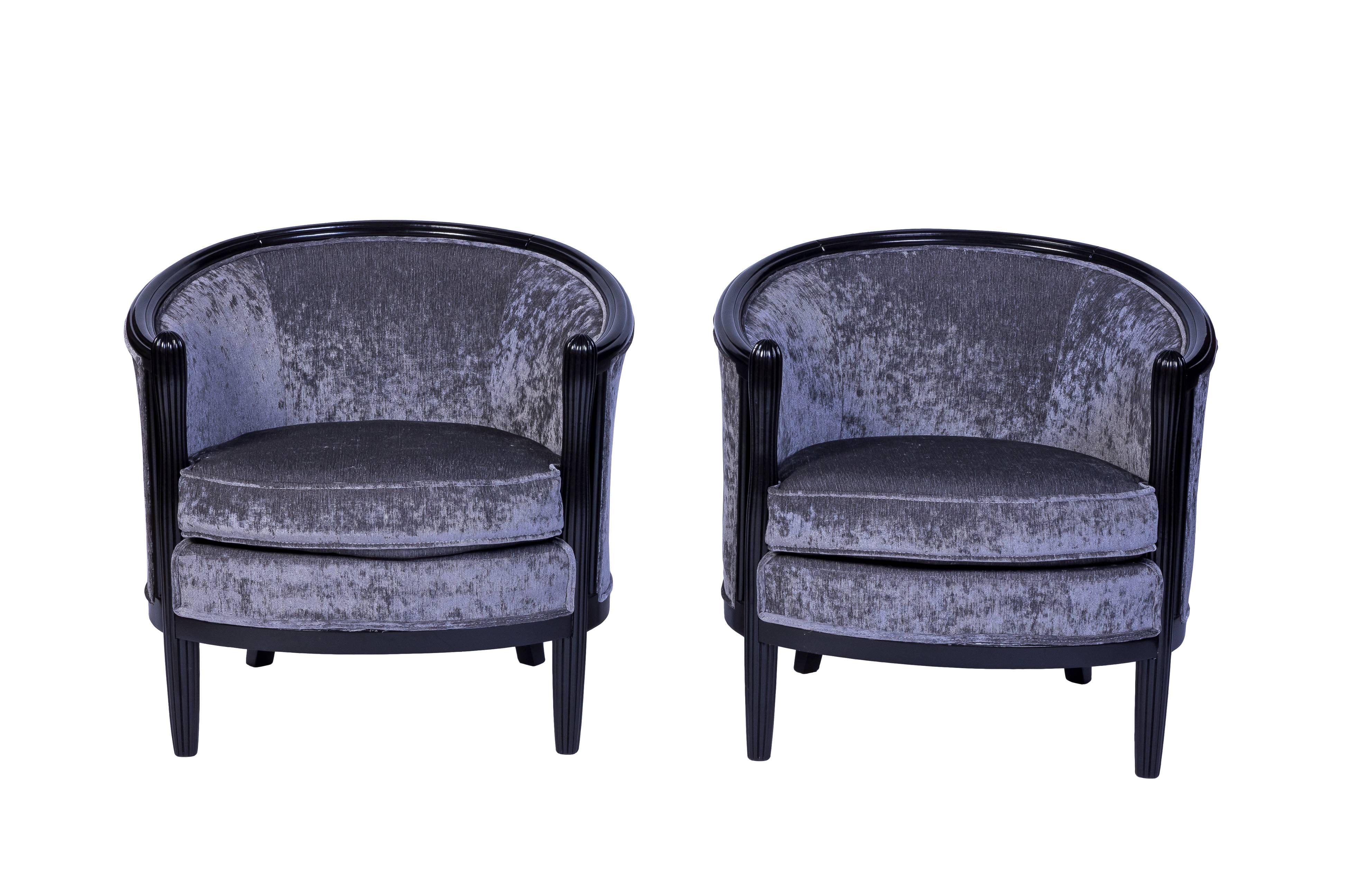 Magnificent pair of ebonized solid mahogany club chairs in the style of Paul Follot in luxe gray velvet. They have been newly refinish and reupholstered.