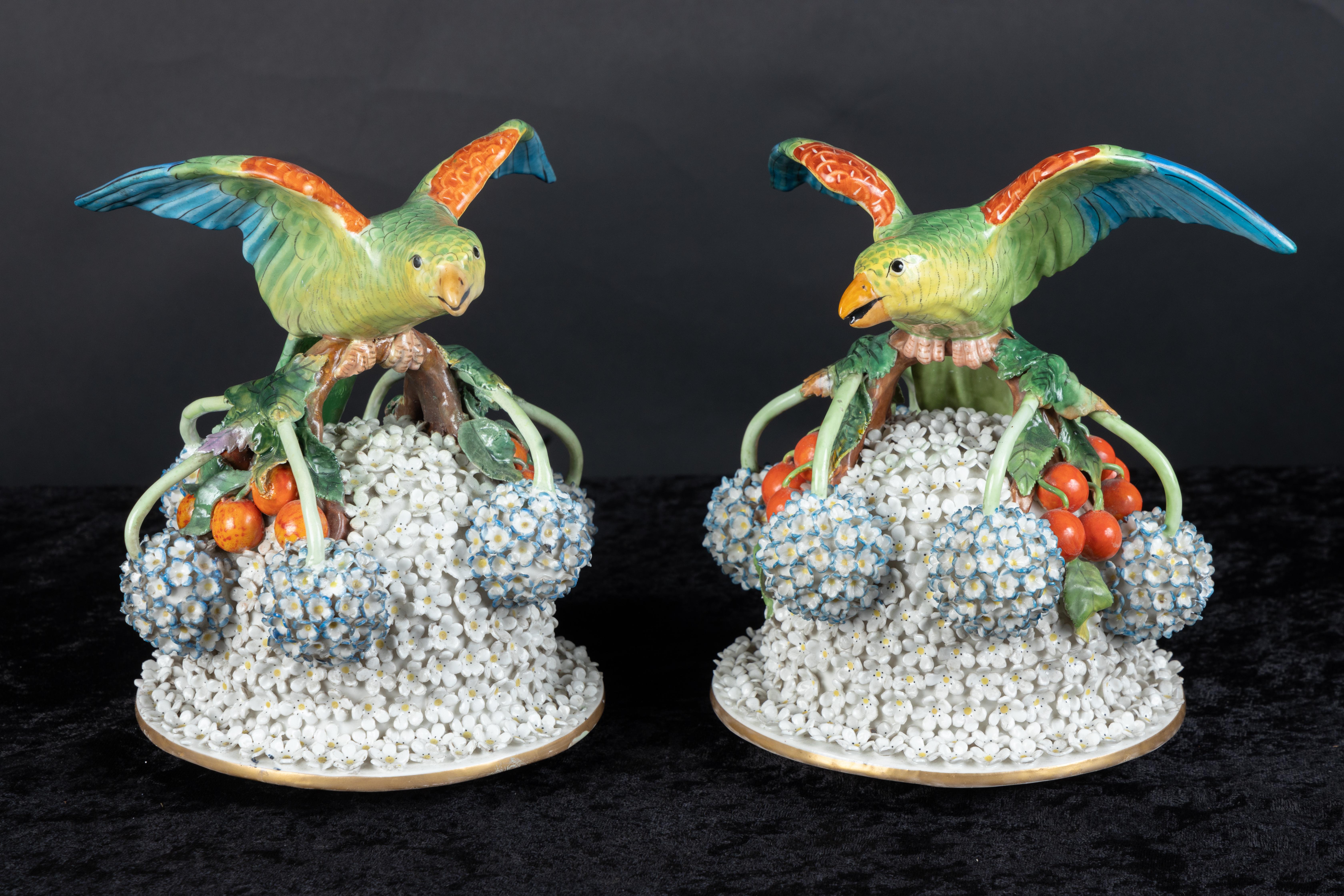 Magnificent pair of Meissen covered vases, decorated with snowball porcelain effect, with winged parrot on top of each cover, above branches, leaves, and berries.  

The entire surface of each vase is decorated 
with snowball porcelain effect.