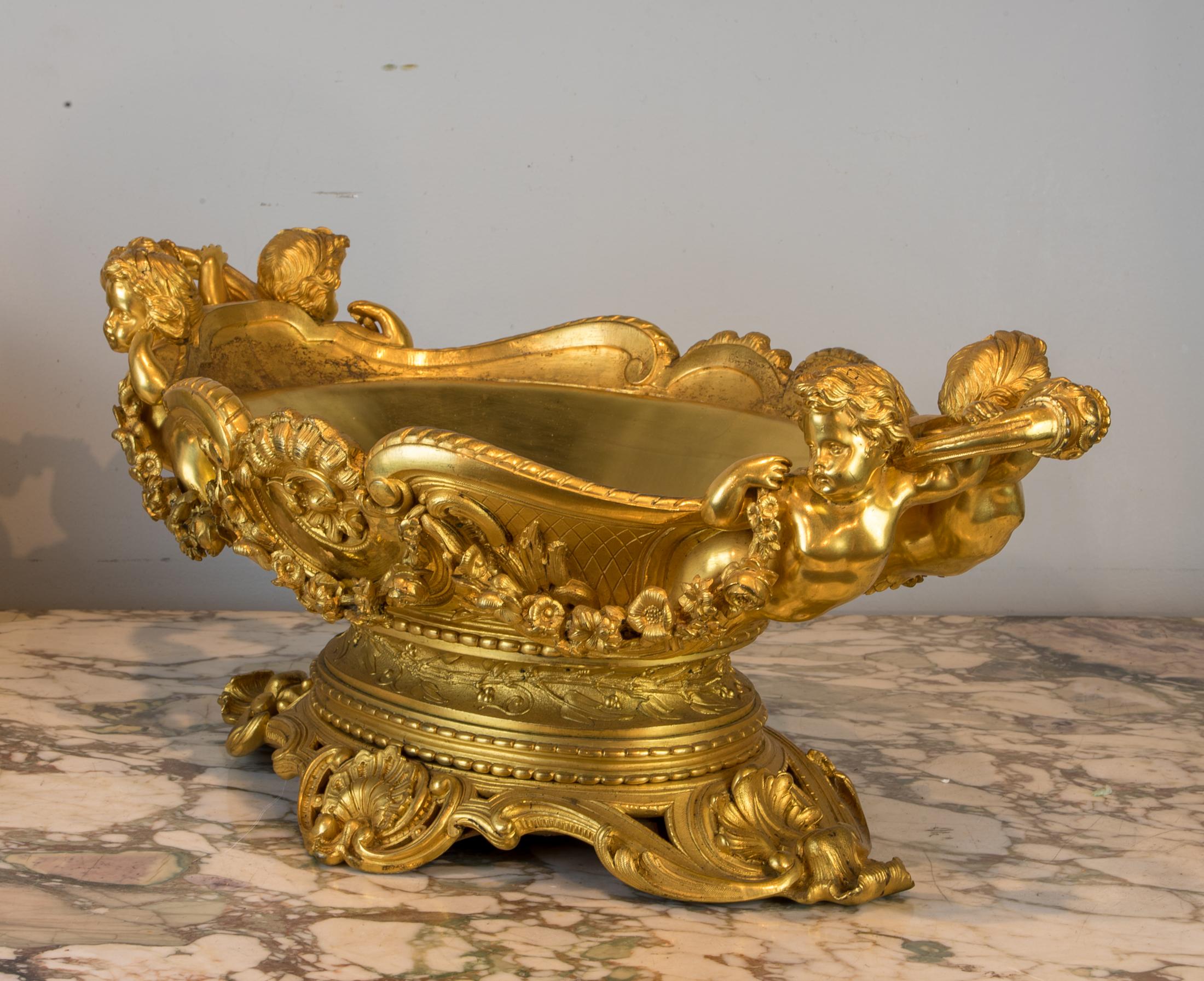 Each flanked by pairs of putti supporting handles and floral garlands, raised on spreading pierced bases.

Origin: French
Date: 19th century
Dimension: 9 3/4 in. x 24 in.
 