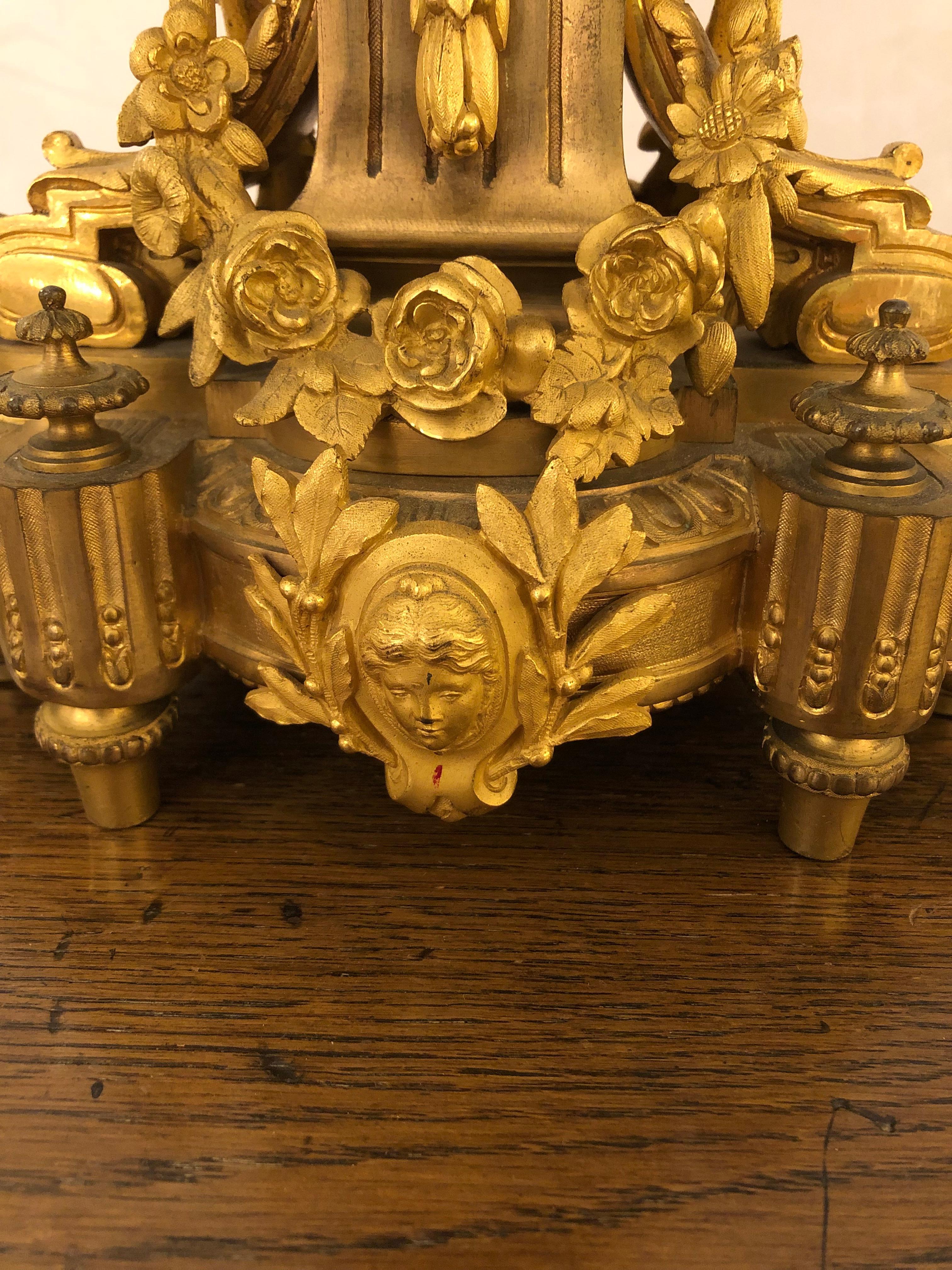 Palatial pair of Neoclassical style relief cast bronze and gilt bronze mounted 7 light candelabras having scrolled arms over a gilt floral wreathed fluted base, above an elaborate second base with garlands and floral bocage. Coin like medallions