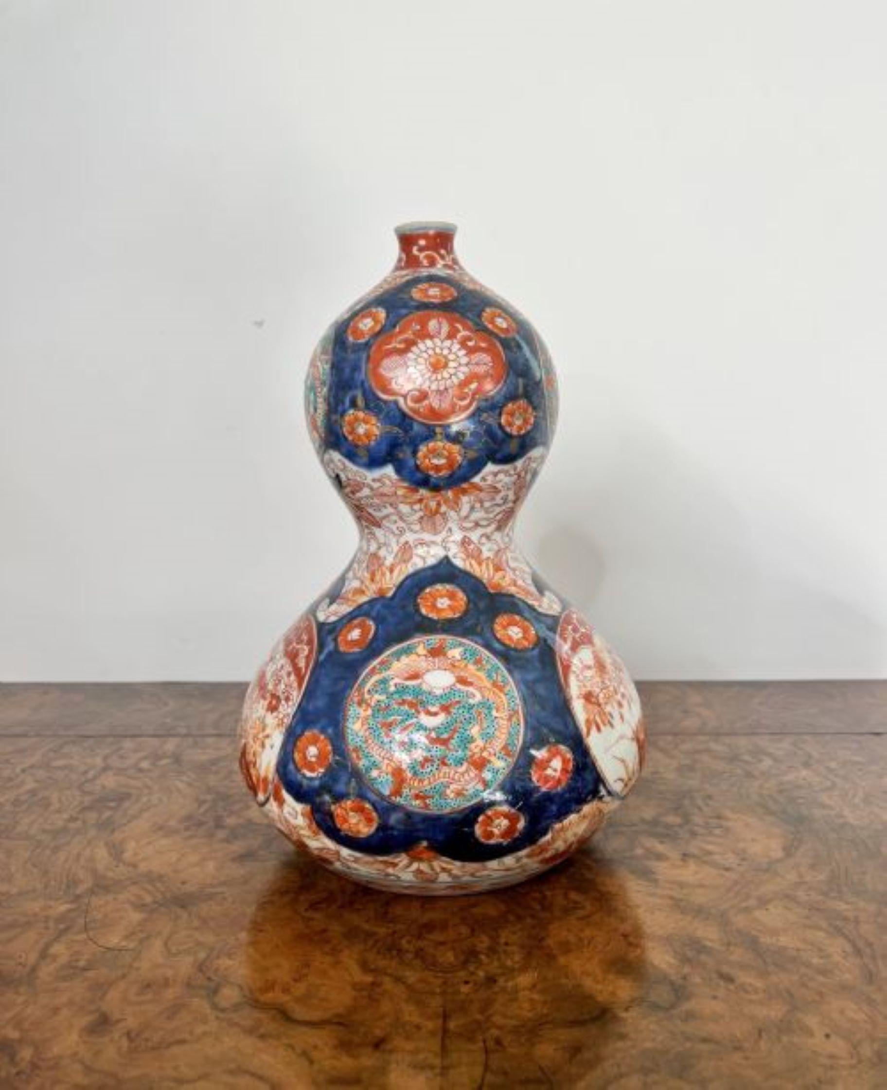 Magnificent pair of unusual shaped antique Japanese imari vases having a quality pair of antique Japanese imari vases with an unusual bulbous shape, wonderful hand painted panels with flowers, trees, scrolls and patterns in fantastic red, blue,