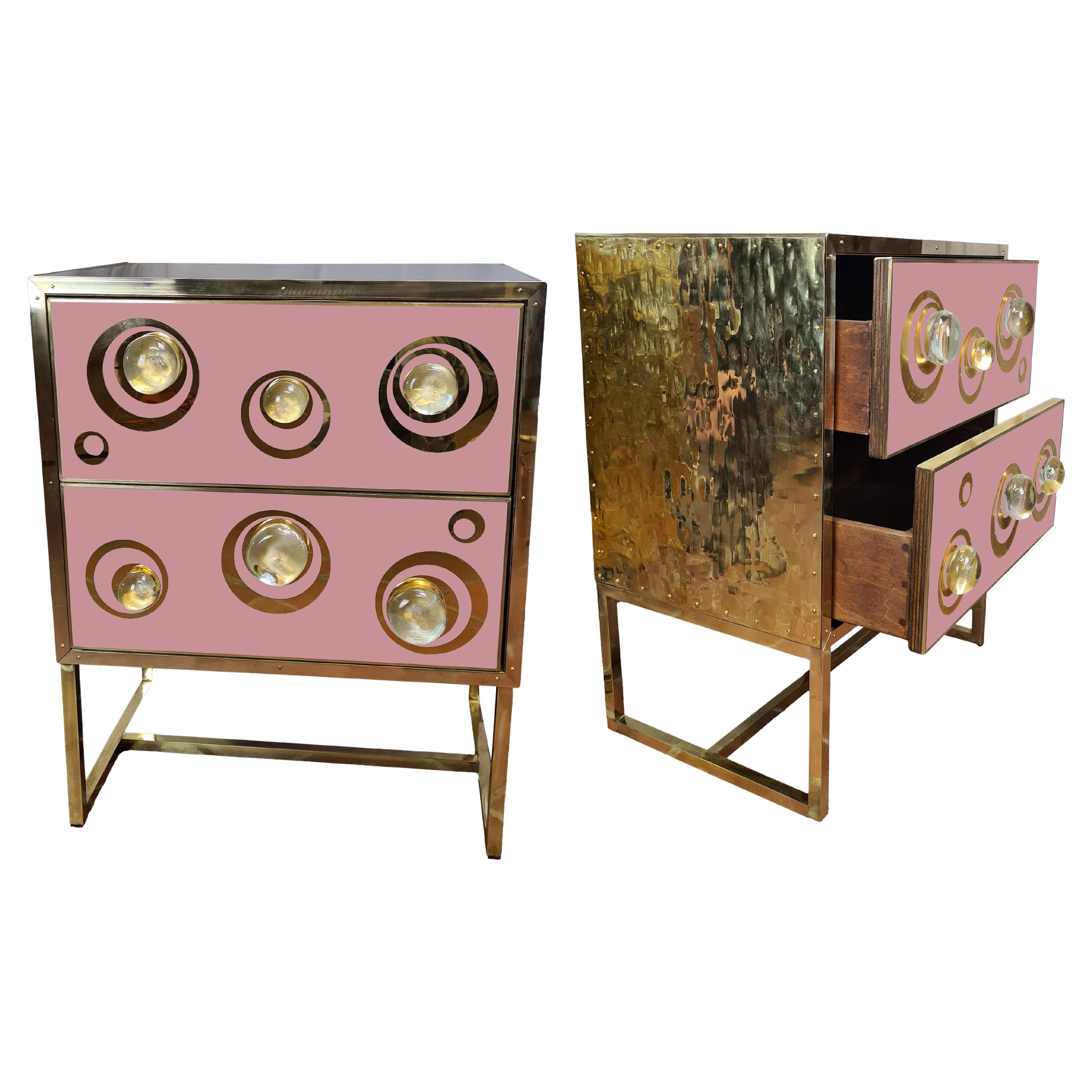 These magnificent pink Italian bedside tables are a true testament to Italian-Venetian craftsmanship, with exquisite Murano glass spheres embellished with brass inserts and elegant slender legs.

Made of solid wood, these nightstands combine