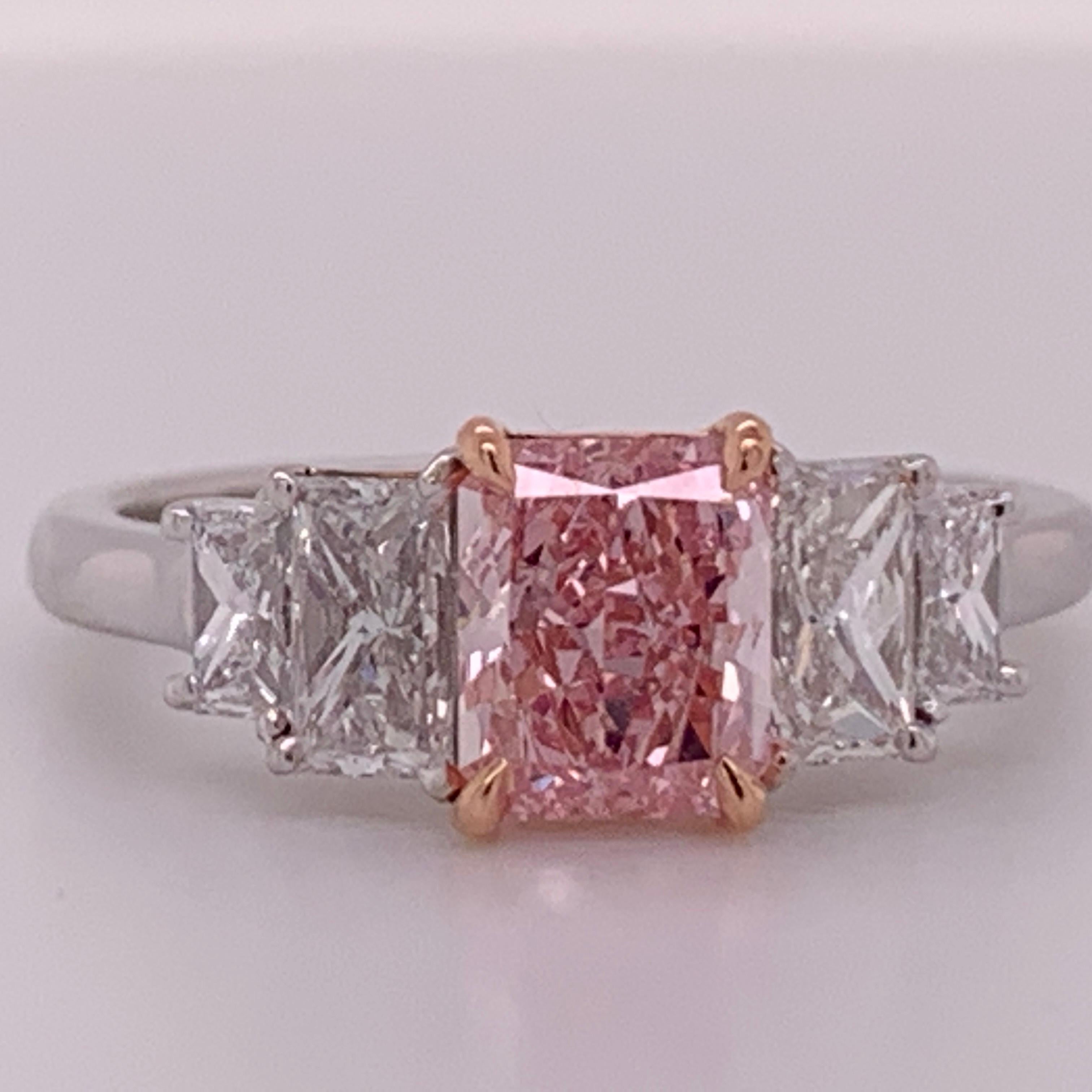 A rare Platinum Ring Radiant Cut 0.88 carat Fancy Intense Pink GIA vs2, no fluorescence. 

Set with four rectangular diamonds weighing 0.81 carats, approximately F in color and VS1 in clarity.