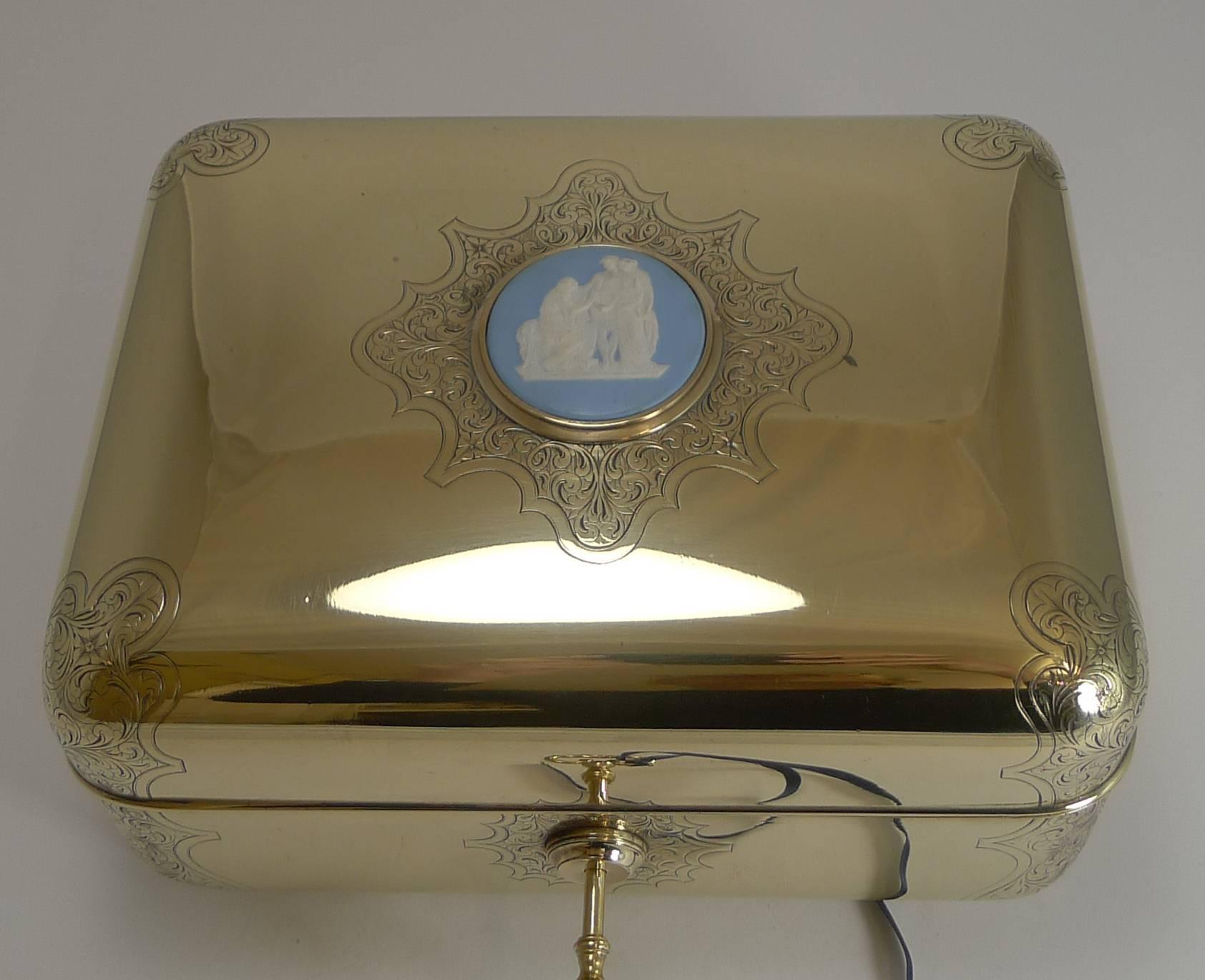 A magnificent top quality and very heavy jewelry casket or box made from cast bronze or brass, polished to gleam.

The box with it's rounded corners has beautiful panels of hand engraved decoration and a Wedgwood jasper plaque inset in the centre