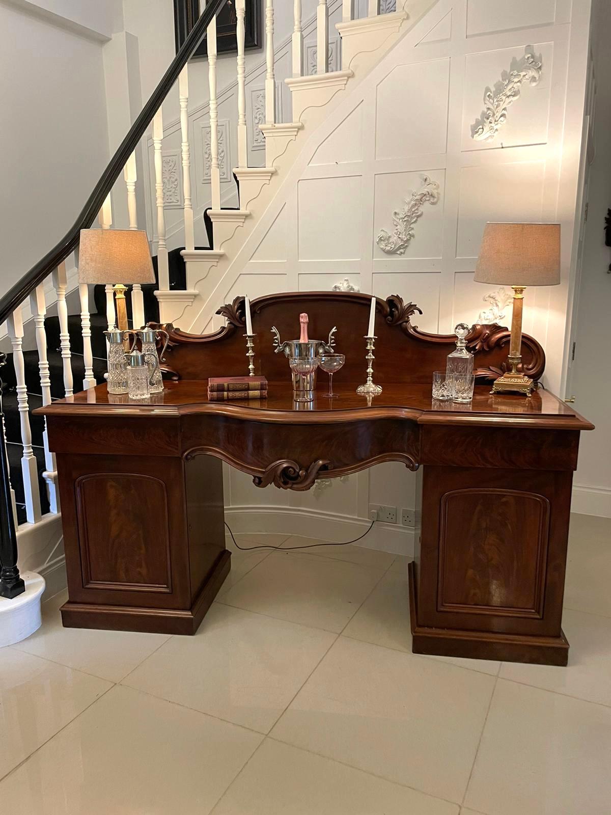 Magnificent quality antique Victorian mahogany sideboard having an attractive shaped carved back, super quality mahogany serpentine shaped top with a moulded edge, 3 frieze drawers, 2 cupboard doors with moulded panels, fitted interior standing on a