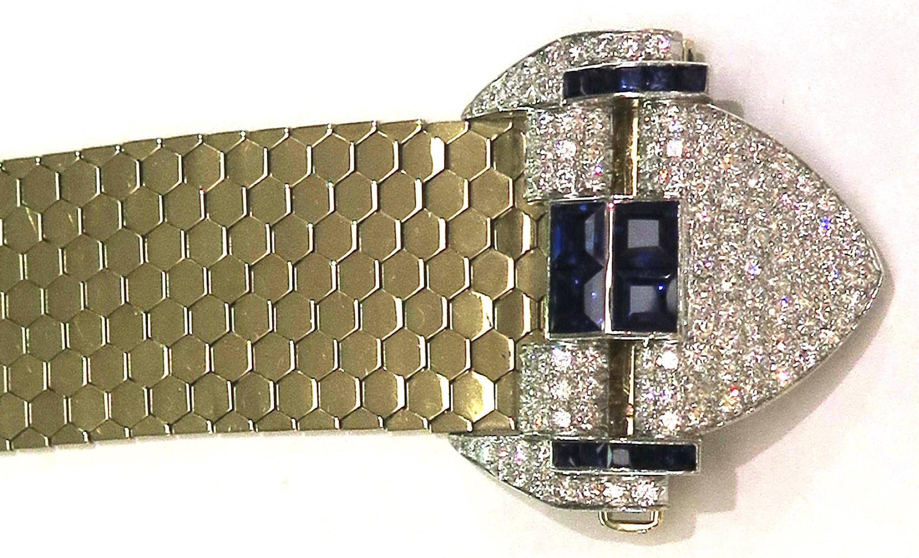 This stunning 18 Karat yellow and white gold retro diamond and sapphire buckle bracelet features a liquid gold flexible hexagonal honeycomb link for superb comfort and wearability. There are approx 3.40 ct diamonds and  approx. 2.70 carats of blue