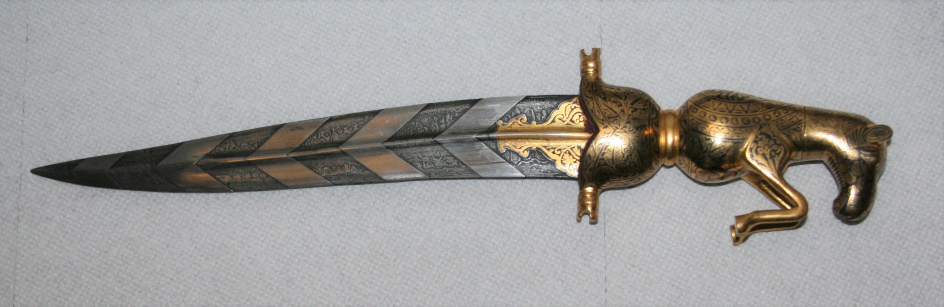 This is an extraordinary dagger with the hilt and metallic sheath completely filled with damascened gold work. The most important part, the blade is watered damascus steel. Please see close ups of both sides of the blade and view the inimitable