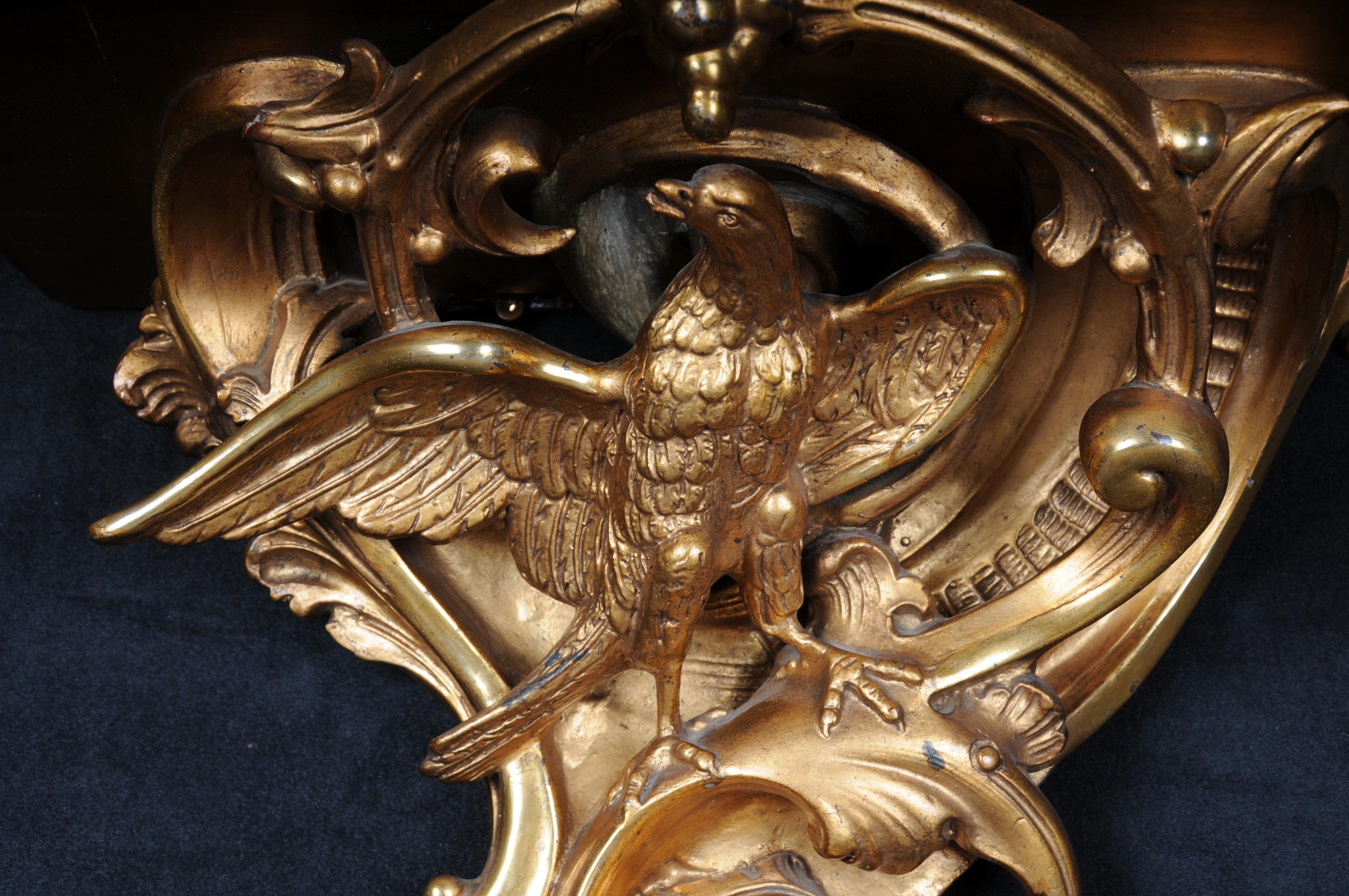 Magnificent Rococo wall console with eagle, gilded.

Wood/stucco, gilded. Matching filing on rocaille eagle sculpture. Best. 2nd Half of the 19th century 35x 49x 28 cm.