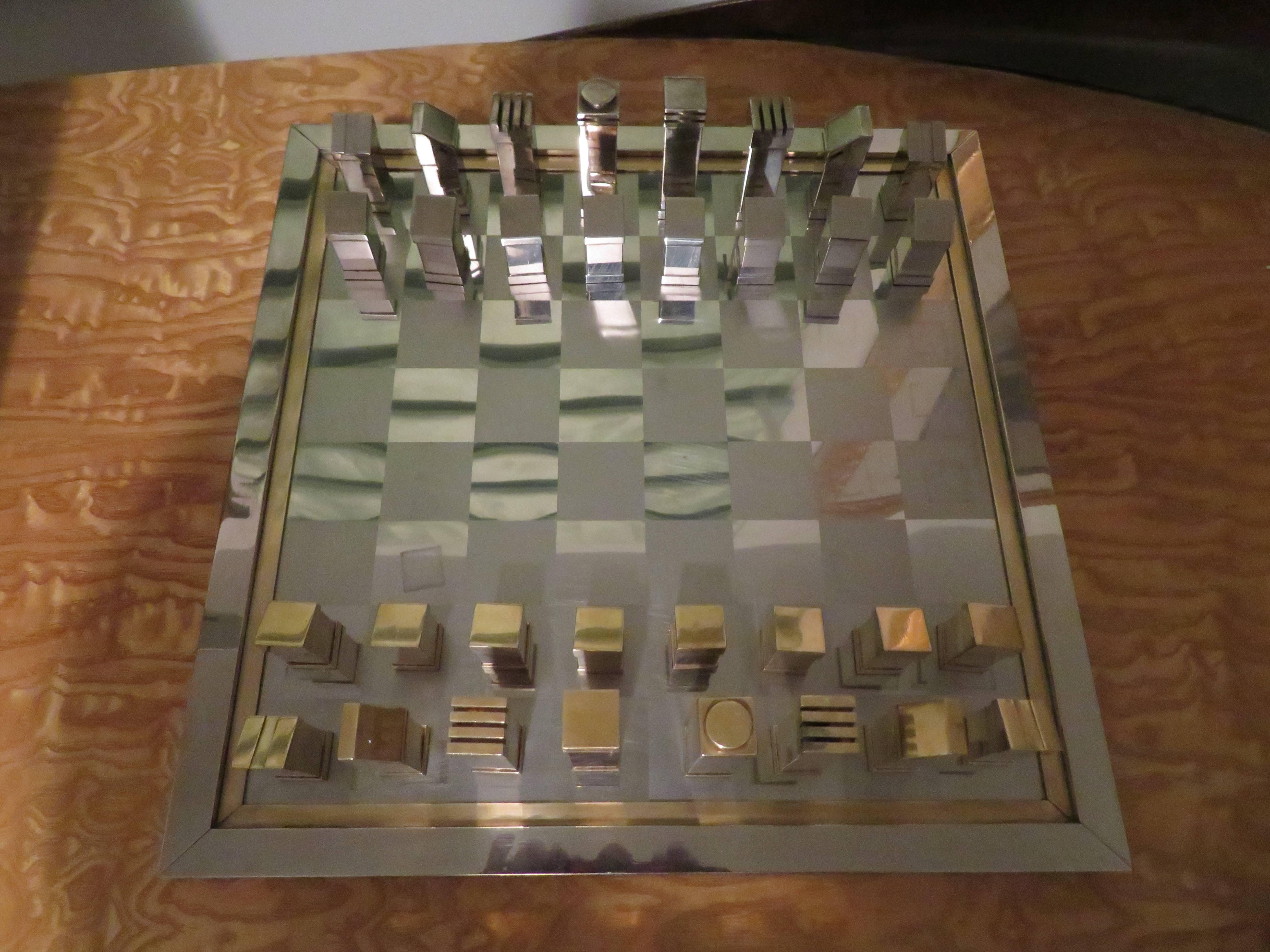 
A magnificent 1970s Italian chess set by Romeo Rega. Constructed of polish chrome and brass. The board is signed Romeo Rega made in Italy on the side.

Dimension: 
Board 16.75” wide 16.75” deep and .75 high.
Game pieces 3.5” high tallest 2”