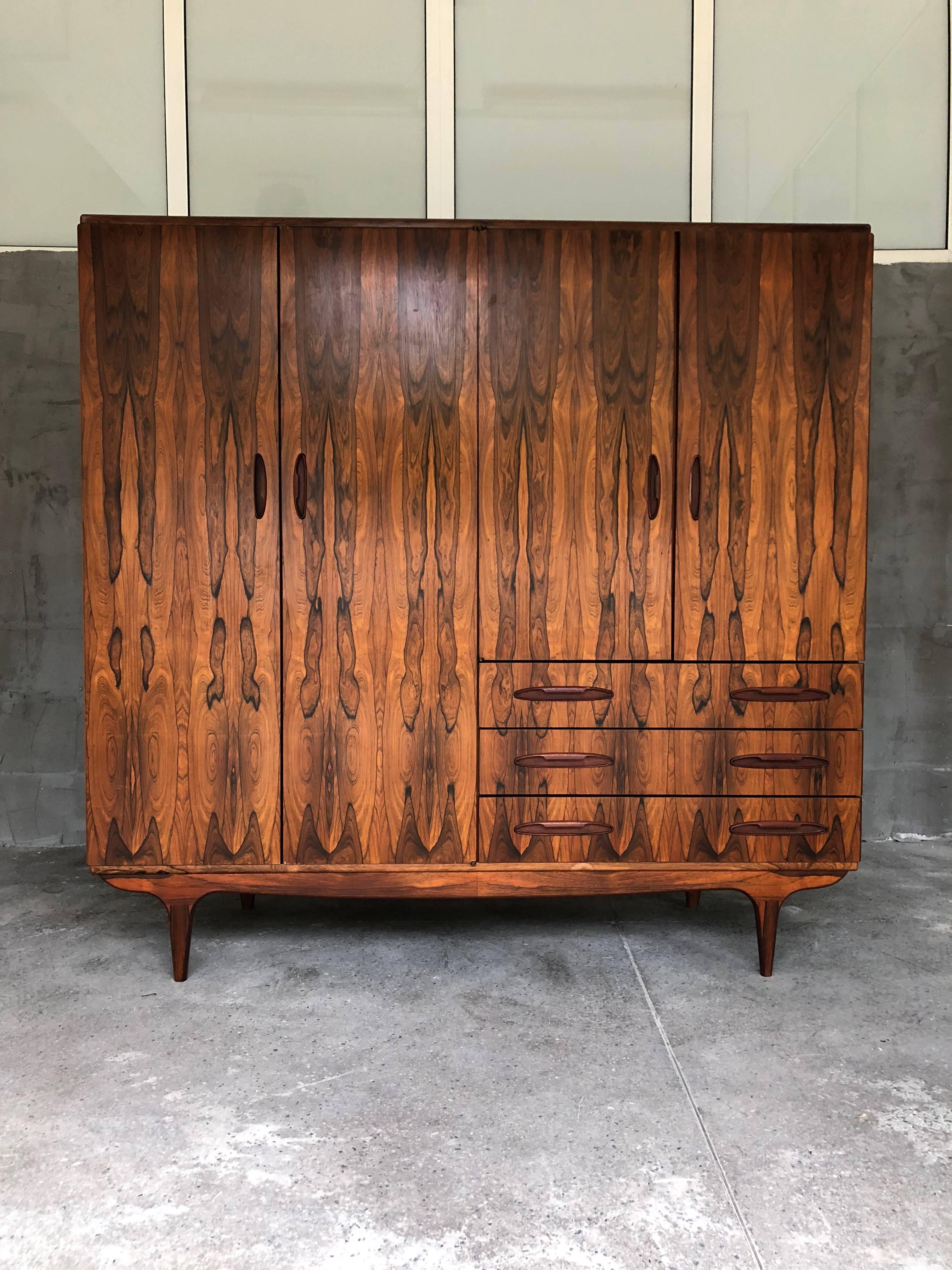 Exceptional and very rare to find Scandinavian style Rio palisander armoire from the 1960s bought in Paris. One of the teck handles was broken but restored. Otherwise in excellent condition. But still minor traces of age and use could be visible on