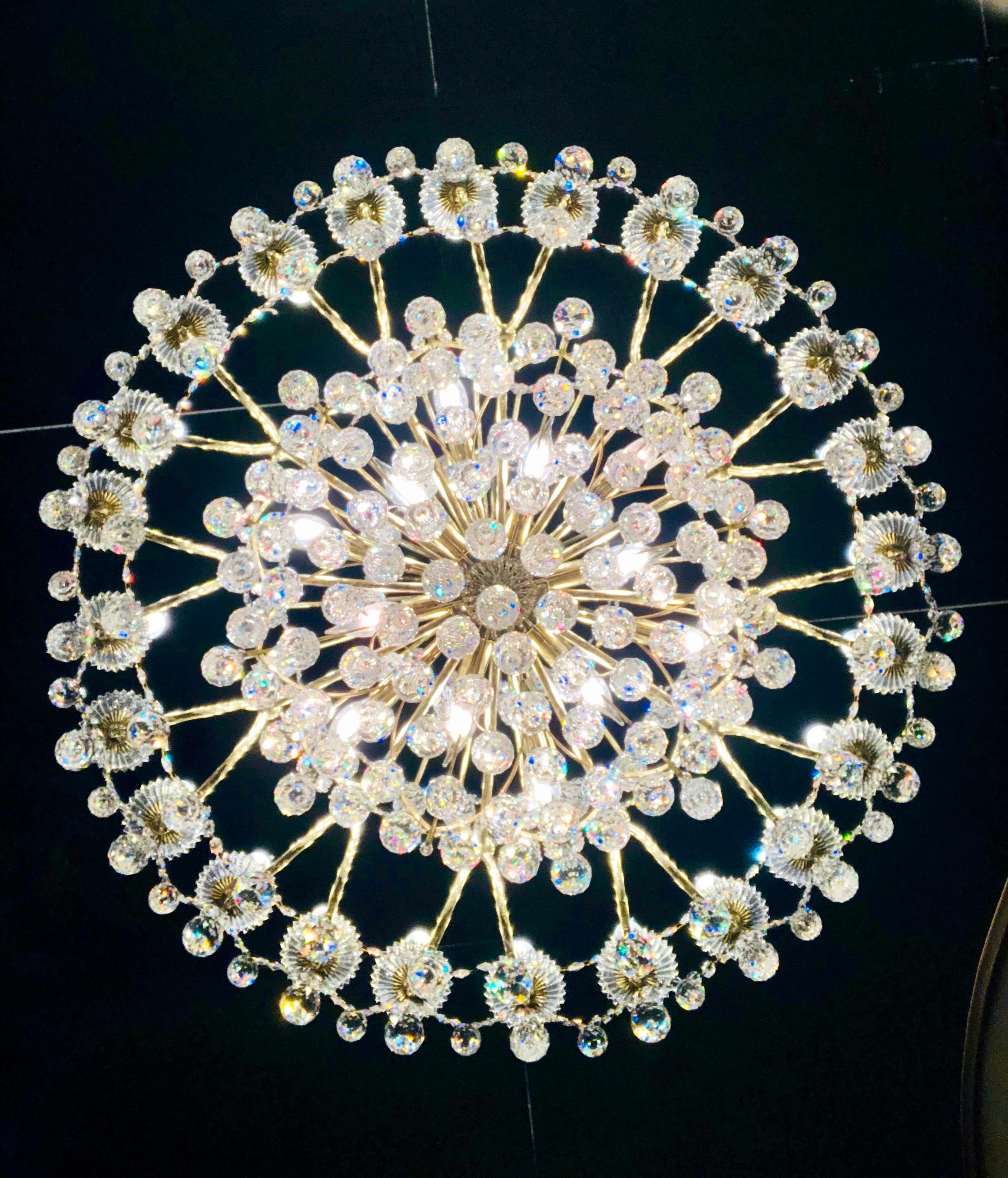 From a mansion estate, this Schonbek Contessa 36 light chandelier with a gold finish metal frame blossoms like a rare flower, with a graceful, hand-formed crystal body and a kaleidoscope of dense crystal ornaments. Chandelier features 24 candle
