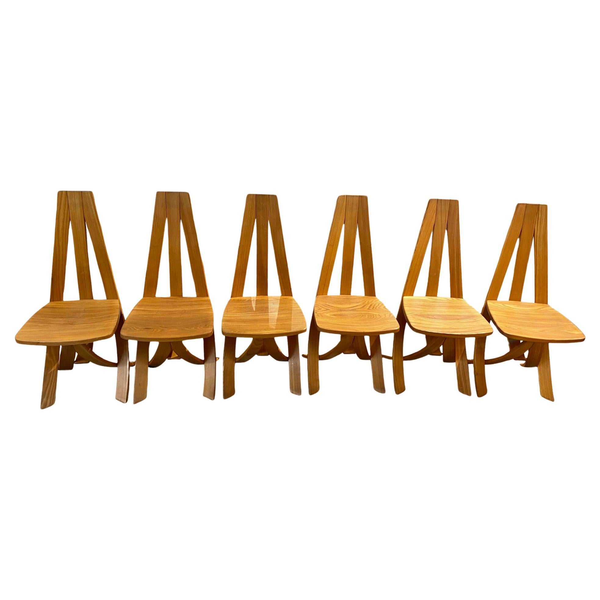 Magnificent series of 6 dining chairs designed in curved solid elm, Circa 1980. 