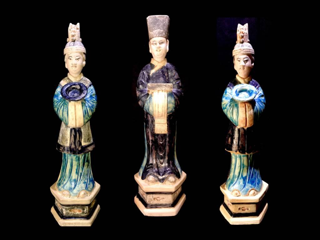 A magnificent set of 3 graceful terracotta figurines from the Ming Dynasty '1368-1644' AD. These elegant courtiers are standing over a high hexagonal plinth and wears fine robes in various blue tones. The unglazed areas have pigmented colors in red,