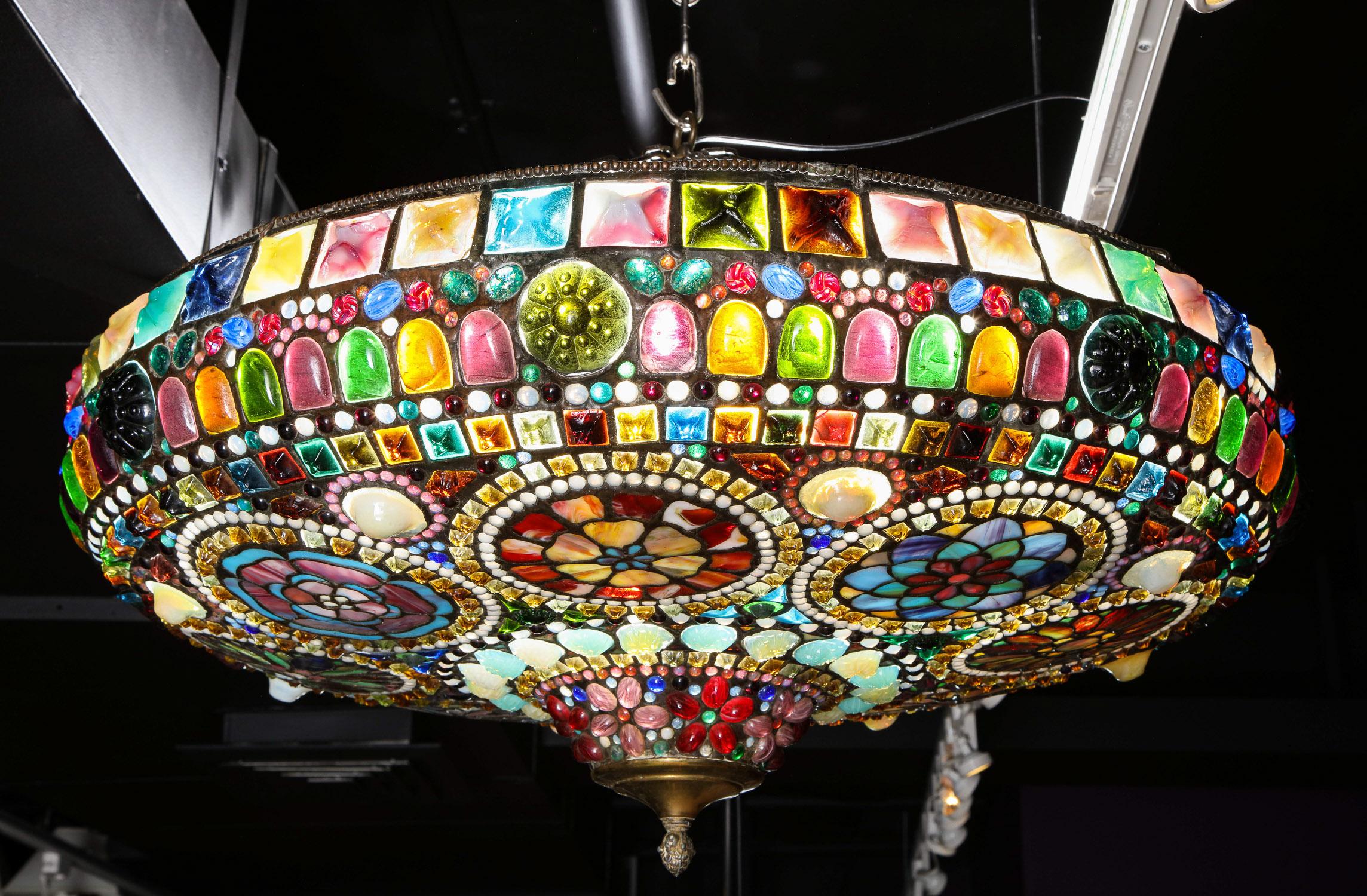 Magnificent stained Tiffany leaded glass ceiling chandelier mount, circa 1960,

This gorgeous circular leaded glass ceiling lamp is crafted from Tiffany Studios workshop glass, including square frogs' back jewels, opalescent glass, and marbleized