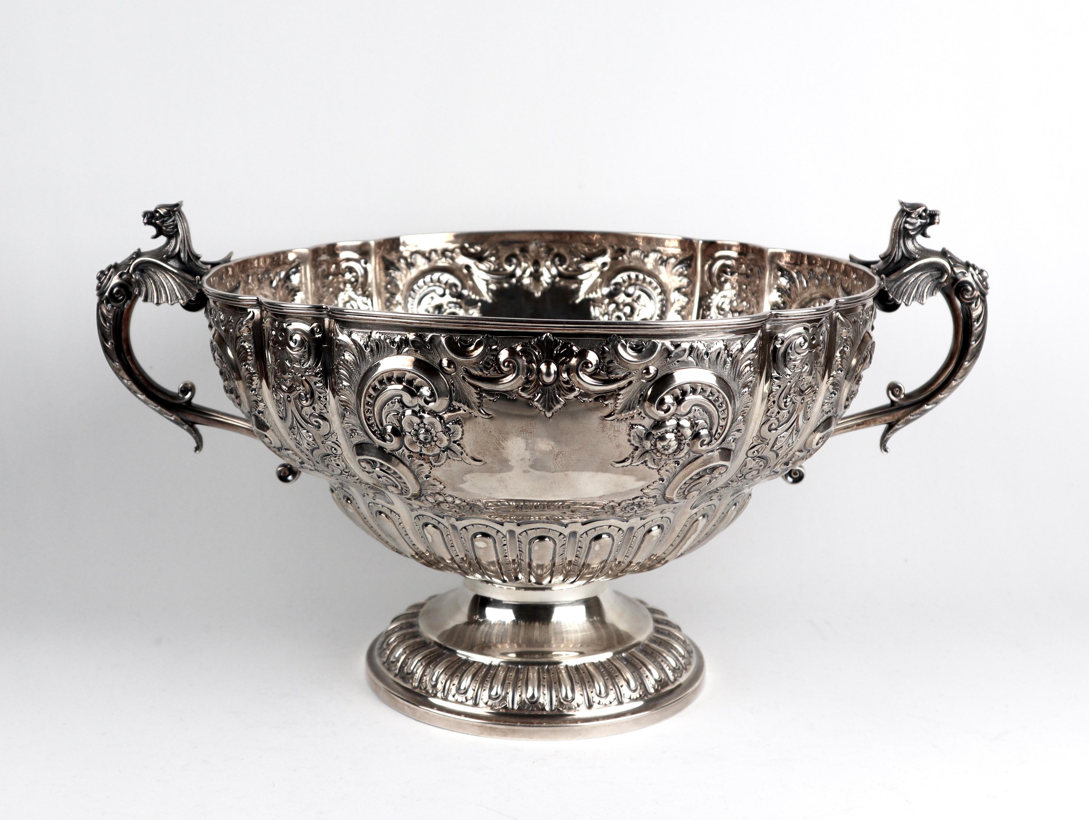 A Magnificent Victorian solid silver punch bowl, shaped circular form, richly embossed, with two winged dragon handles.

Hallmarked for Sheffield 1892
Makers mark SFWS Samuel Fenton and Wiliam Staniforth 

Measures: Length 38.5 cm 
Diameter 27