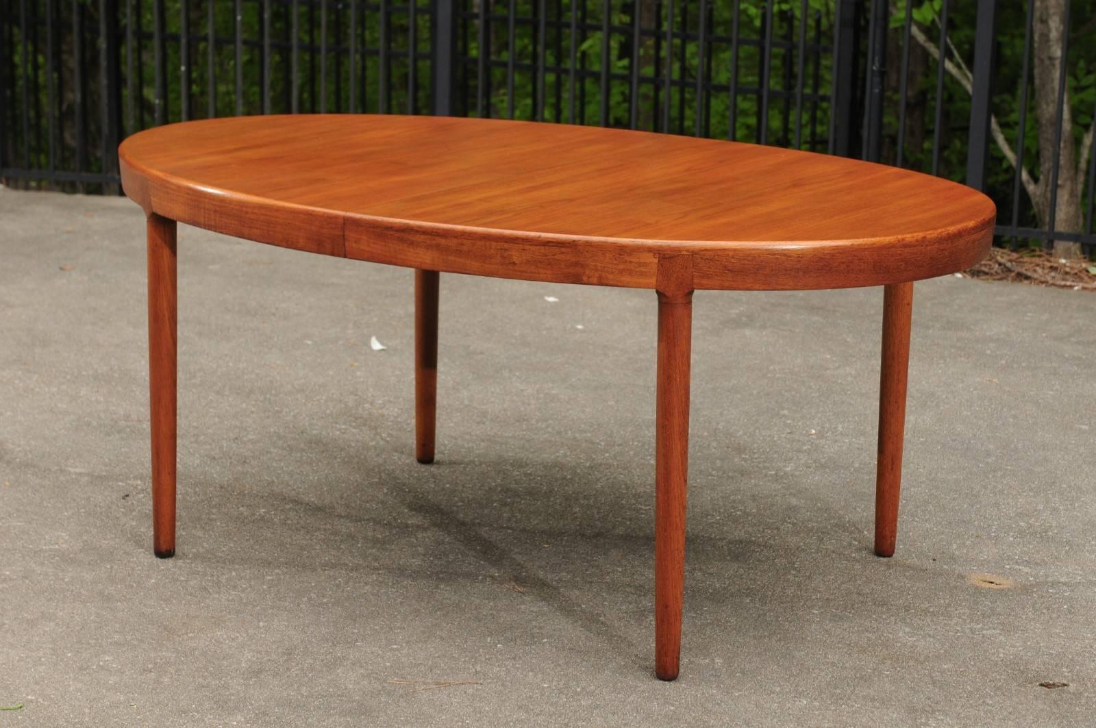 A stunning extension dining table by Harry Ostergaard for Randers Mobelfabrik, circa 1963. Clean and elegant design exquisitely executed in fabulous teak. Craftsmanship that is beyond incredible. A majestic and functional focal piece that will