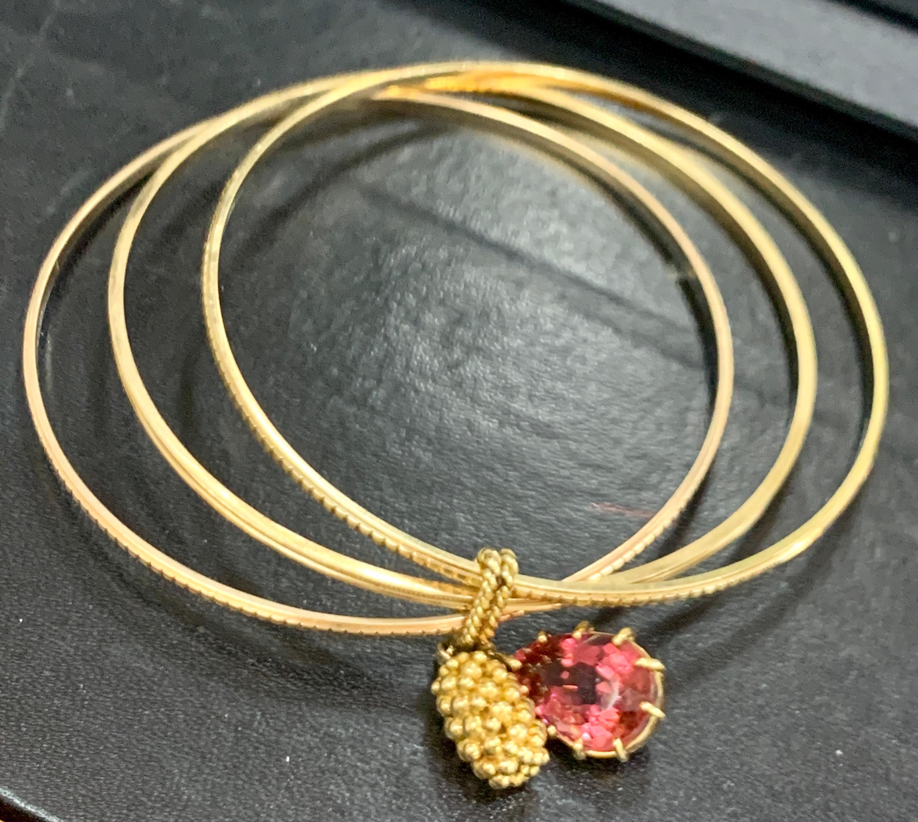 Magnificent Three Yellow Gold Bangle Attached by Pink Tourmaline and Gold Charm In Excellent Condition In New York, NY