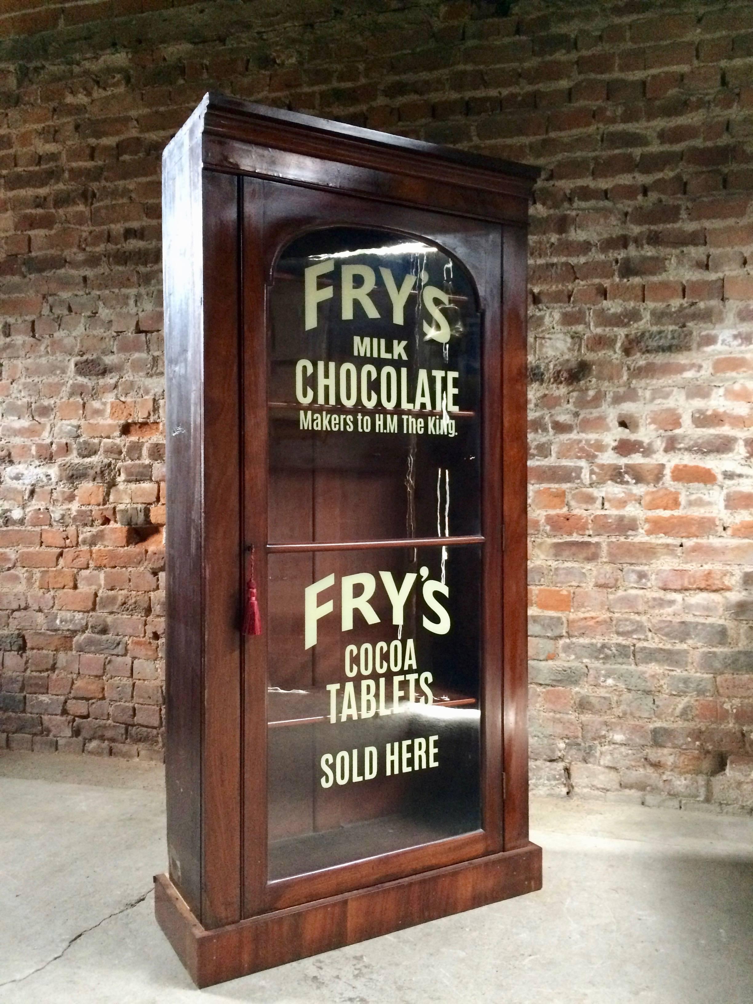 Fabulous antique Victorian Haberdashery style mahogany bookcase enclosed by a single arched glazed door with adjustable shelves within, with applied 'Fry's Milk Chocolate' advertising writing, comes with one working key and