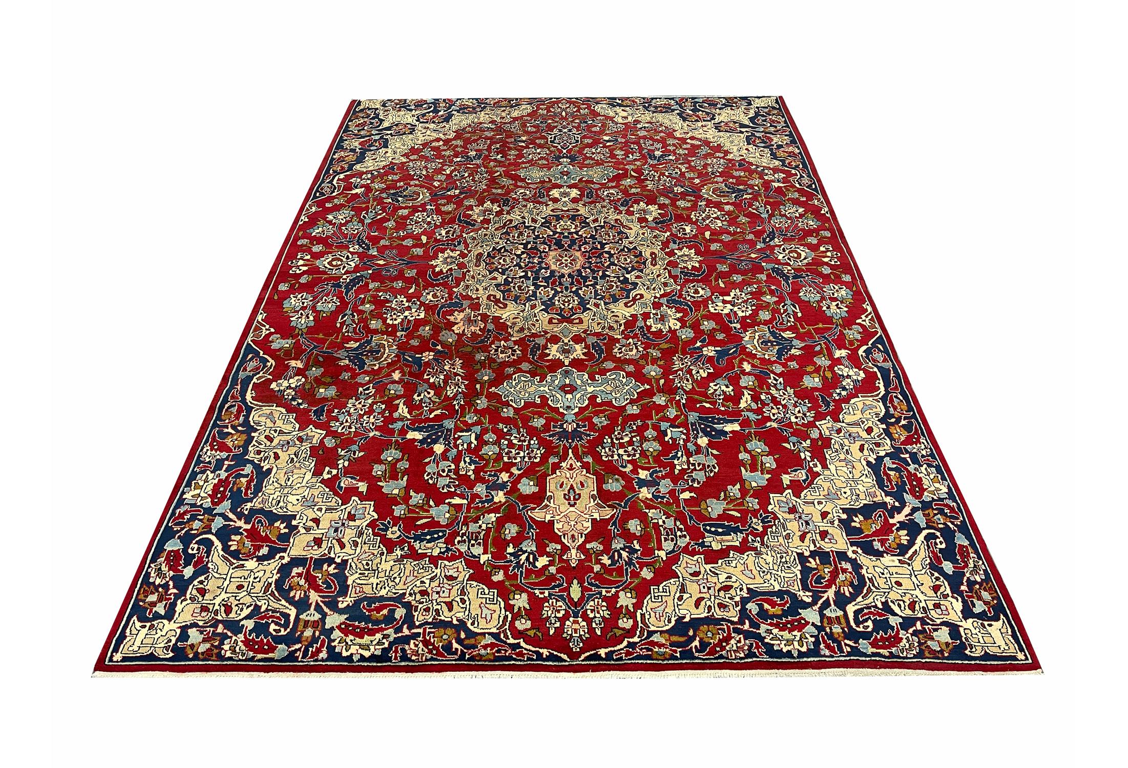 This luxurious carpet has been woven with a rich wine-red background with cream, blue, green and pink accents that make up the intricate, highly-decorative medallion and surrounding design. The floating medallion and complex surrounding patterns